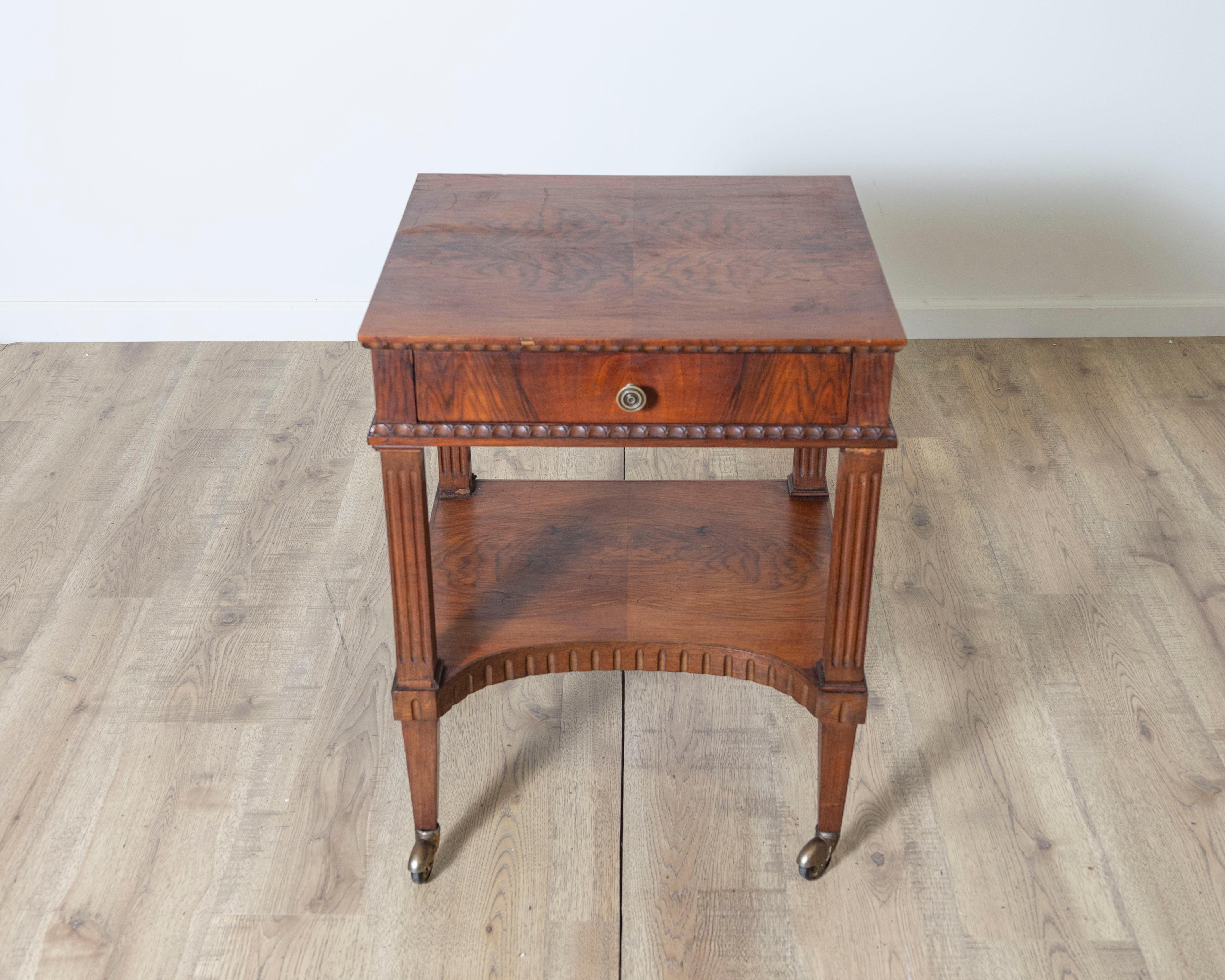 An elegant Italian side table in the Louis XVI style, dating from the 19th century and crafted in beautifully figured walnut. This refined piece exemplifies neoclassical restraint with its clean lines, symmetrical design, and classical
