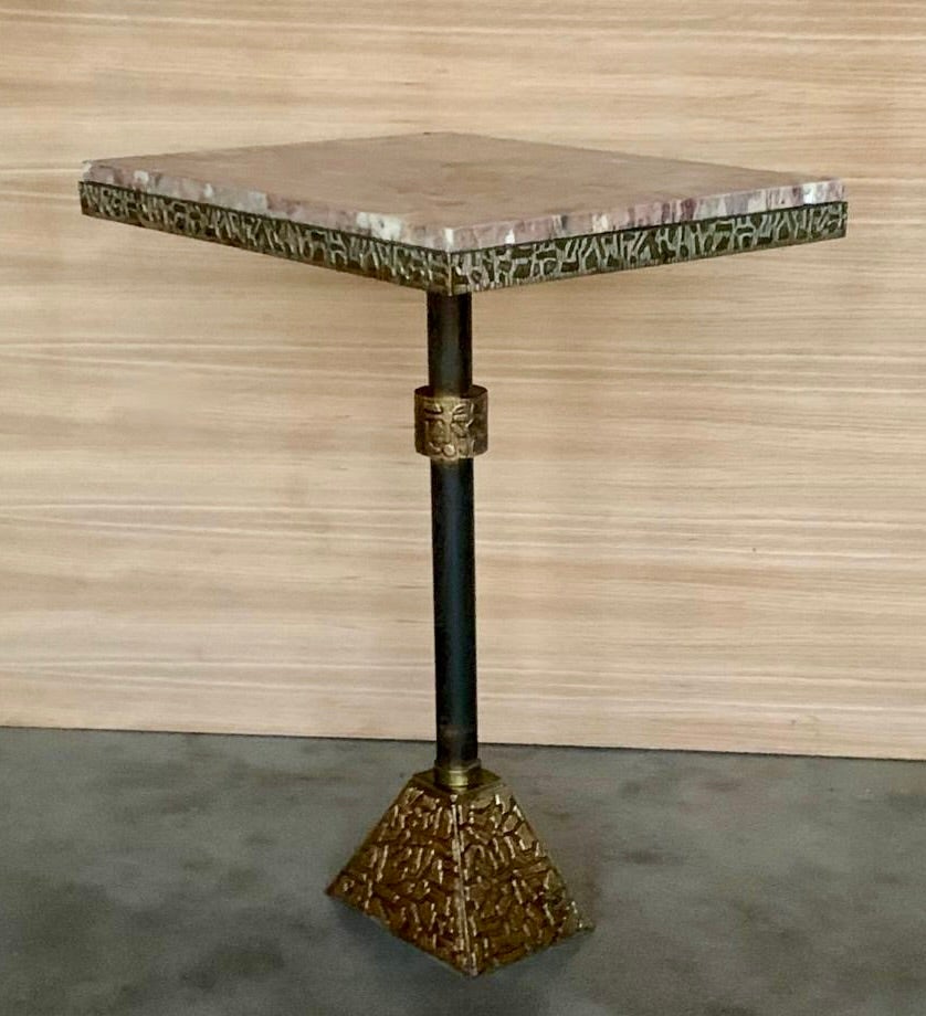 Side table, granite, metal, brass, Italy, 1950s  This side table features a pink granite tabletop in square format. The granite shows a vivid surface. A brass pedestal ends in a engraved bronze trapezoid base with print animal. The composition of