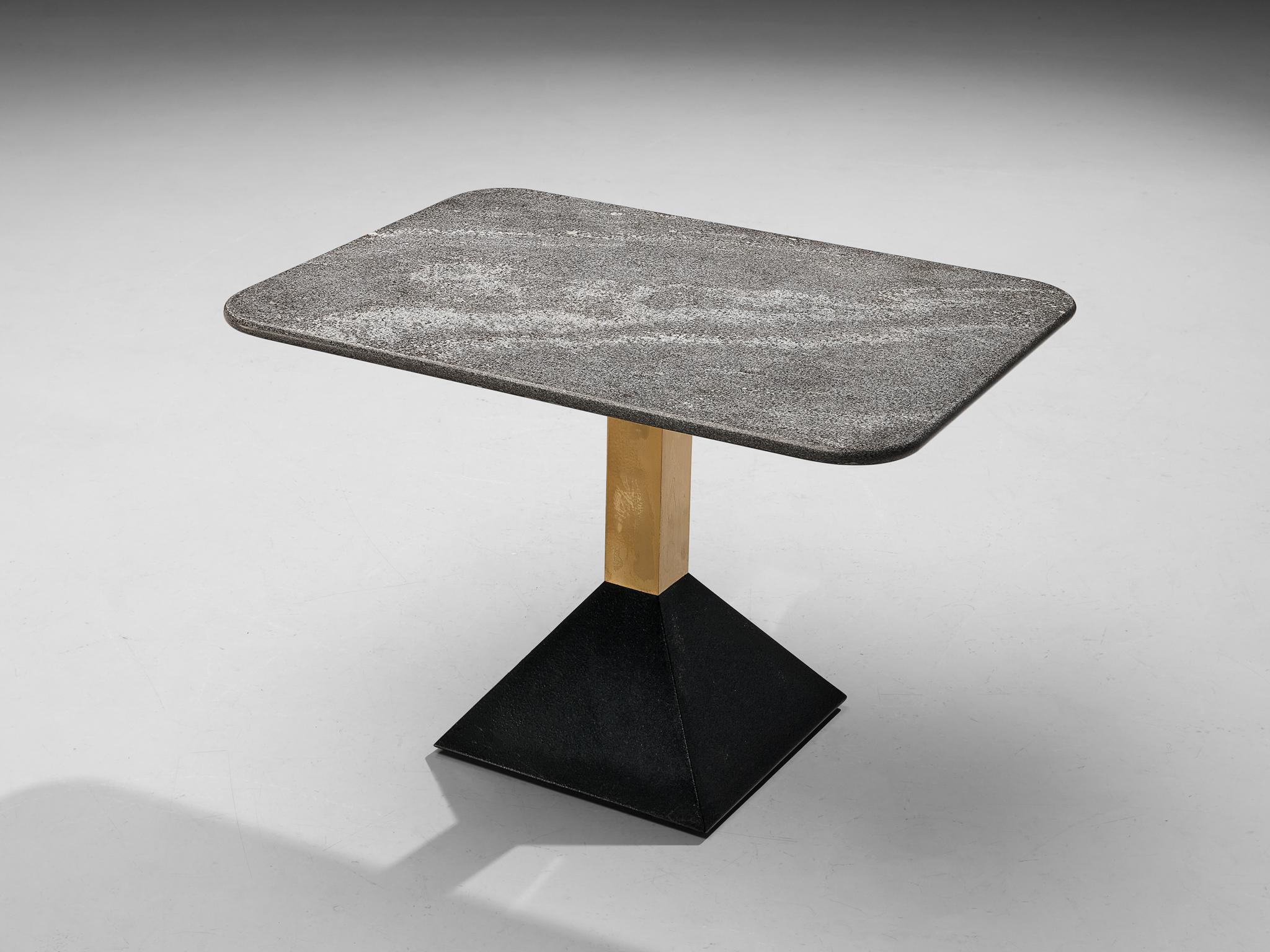 Side table, granite, metal, brass, Italy, 1980s

This side table features a grey granite tabletop in rectangular format. The granite shows a vivid surface. A brass pedestal ends in a black trapezoid base in black metal. The composition of textures