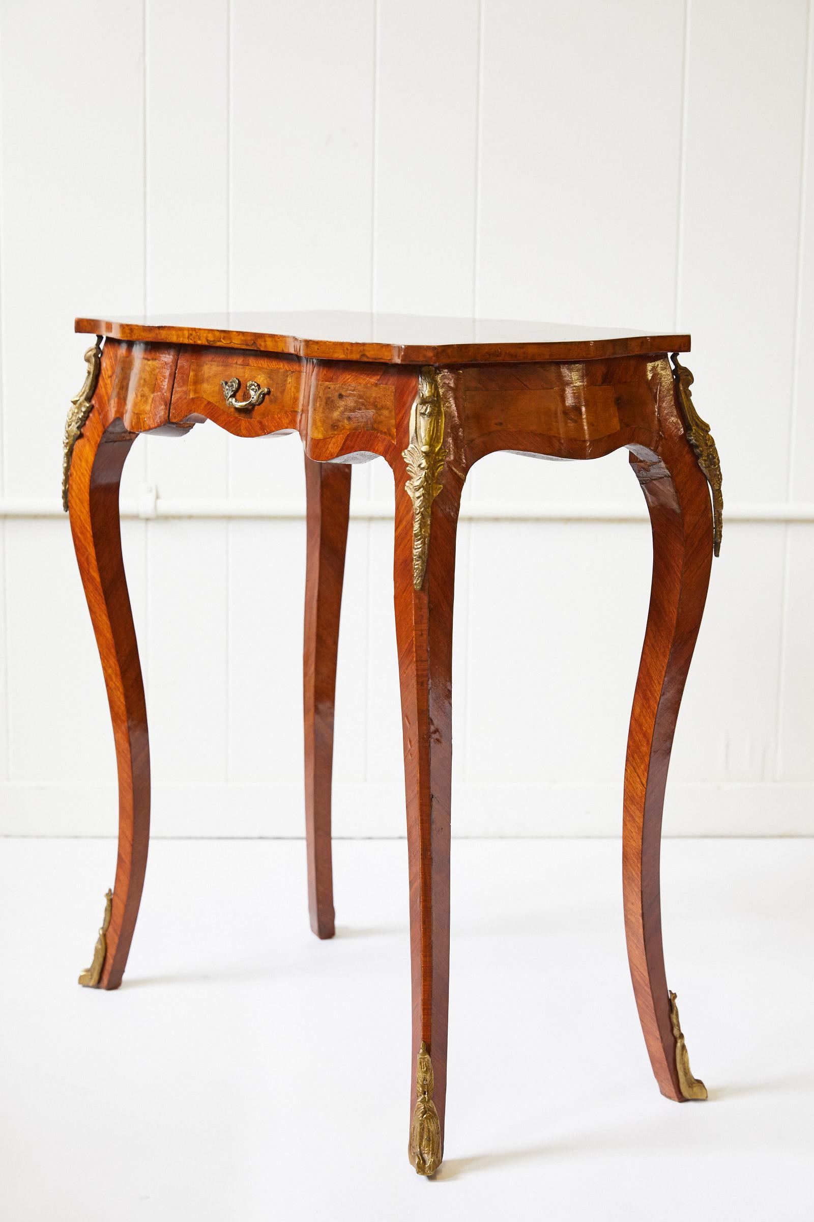 Late 19th century Italian side table of burl walnut and rosewood having a beautifully shaped top inset with a star marquetry inlay. The table is finished on all sides; the sides and back taking a serpentine form while the front has an oxbow shape.