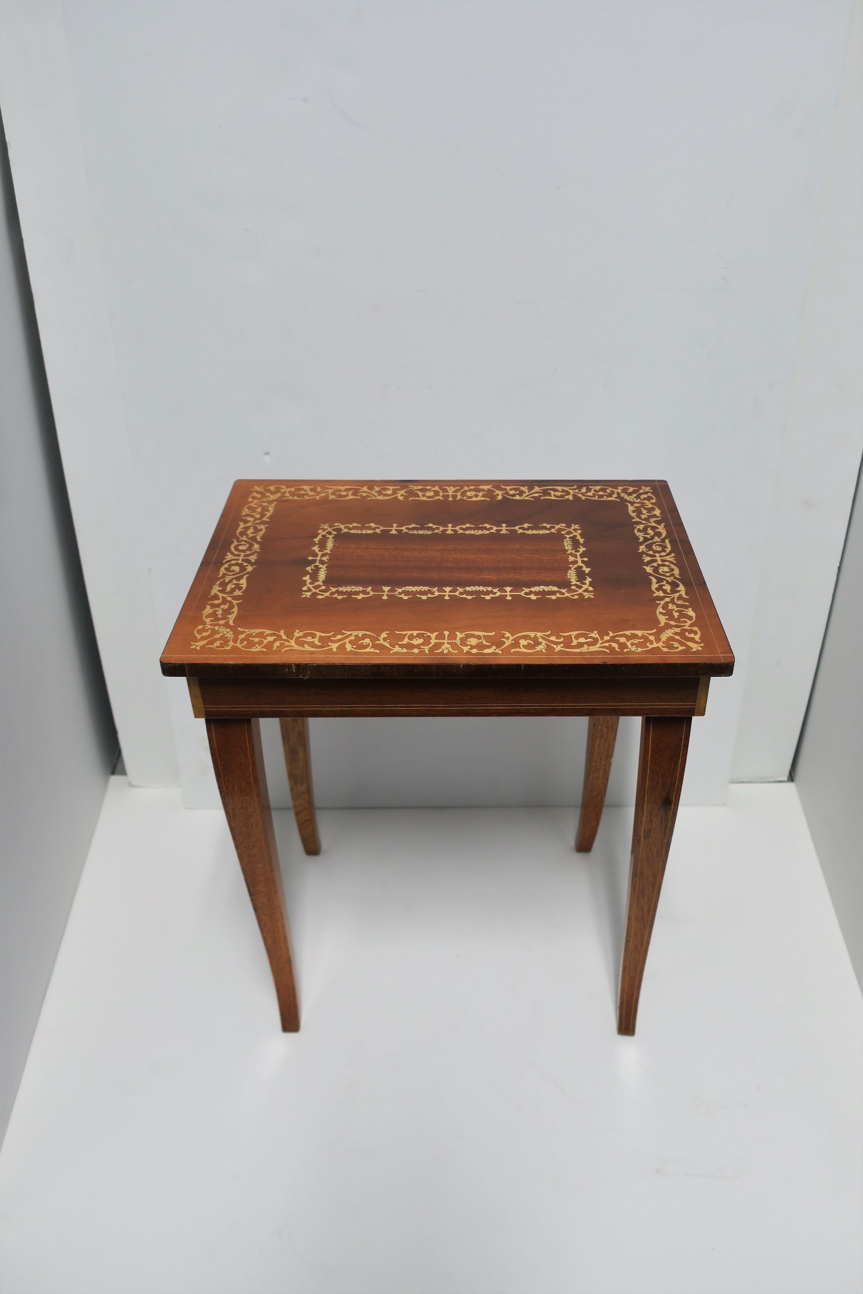 A small Italian rectangular wood side or end table with decorative top, cabriolet legs, private compartment and music box, in the Rococo style, circa 20th century, Italy. This convenient side or end table also doubles as a 'box' and 'music' box;