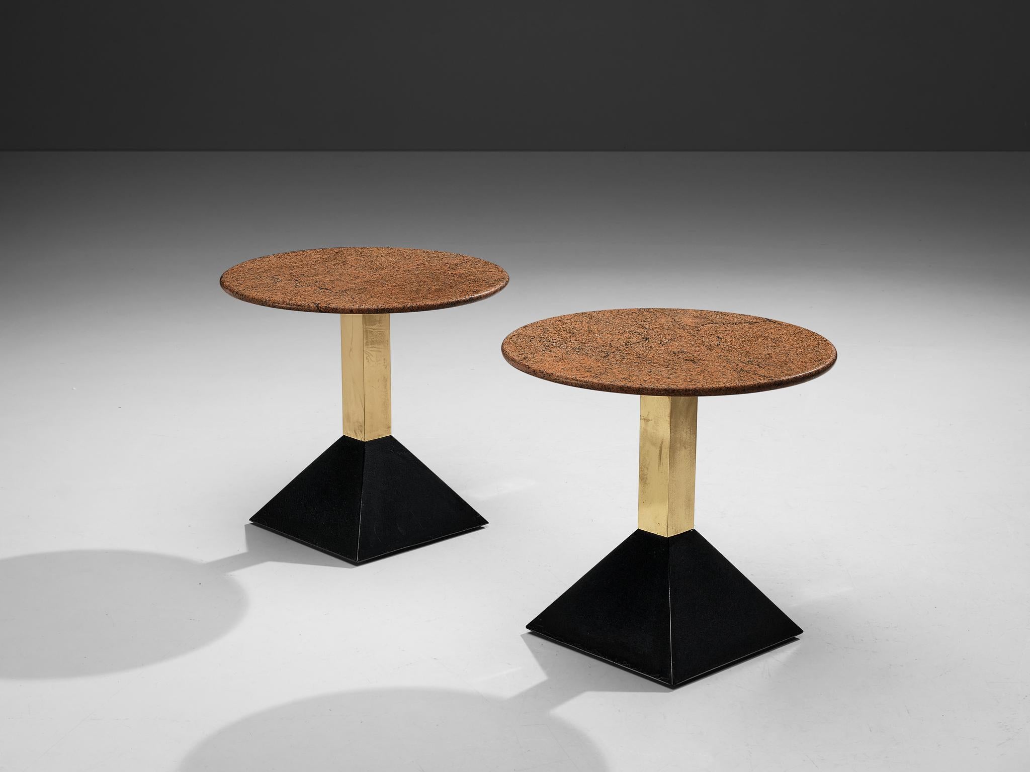 Side tables, granite, metal, brass, Italy, 1980s

These side tables feature a red granite tabletop in round format. The granite shows a vivid surface. A brass pedestal ends in a black trapezoid base in metal. The composition of textures and shapes,