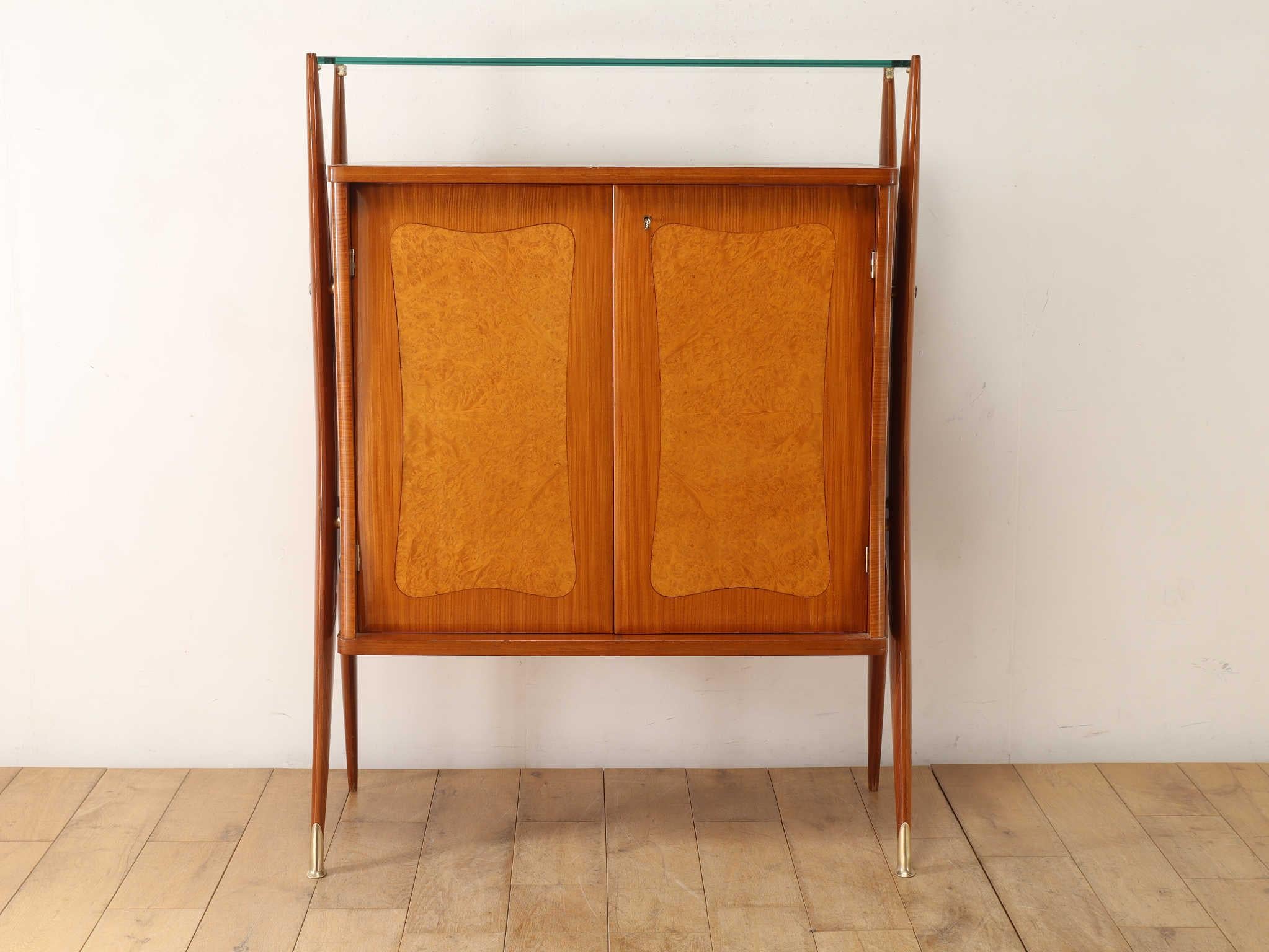 Estimated to be from the 1950s, this Italian vintage sideboard embodies a distinctive fusion of retro charm and futuristic design—a hallmark of mid-century Italian aesthetics. The bold, glossy lacquer finish not only amplifies its visual presence