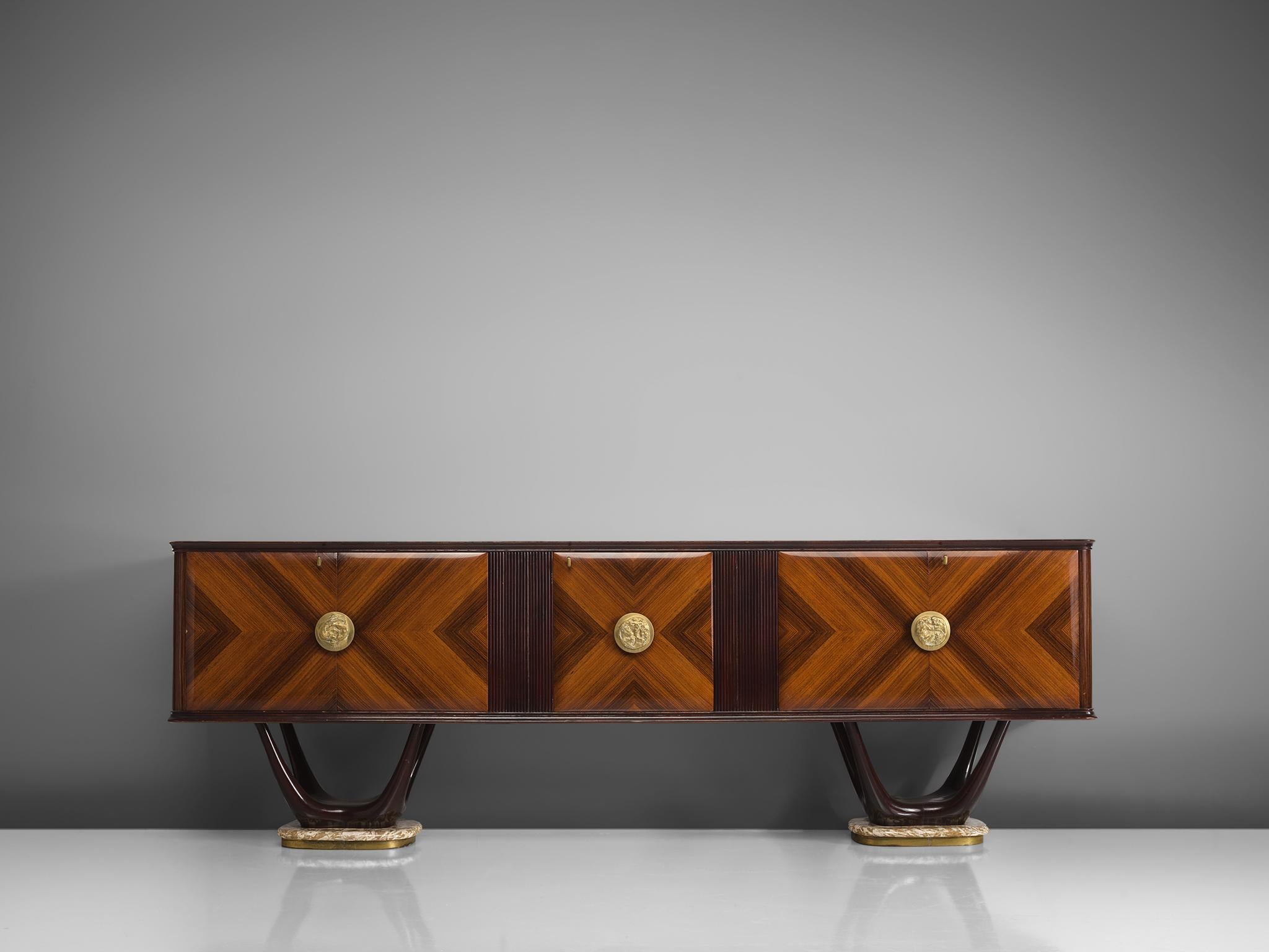 Fratelli Turri, credenza, in mahogany, maple, marble, glass and brass, Italy, 1950s.

This theatrical credenza is designed in the style of Vittorio Dassi. The cabinet itself is made of a mahogany construction. The doors are made of mahogany veneer,