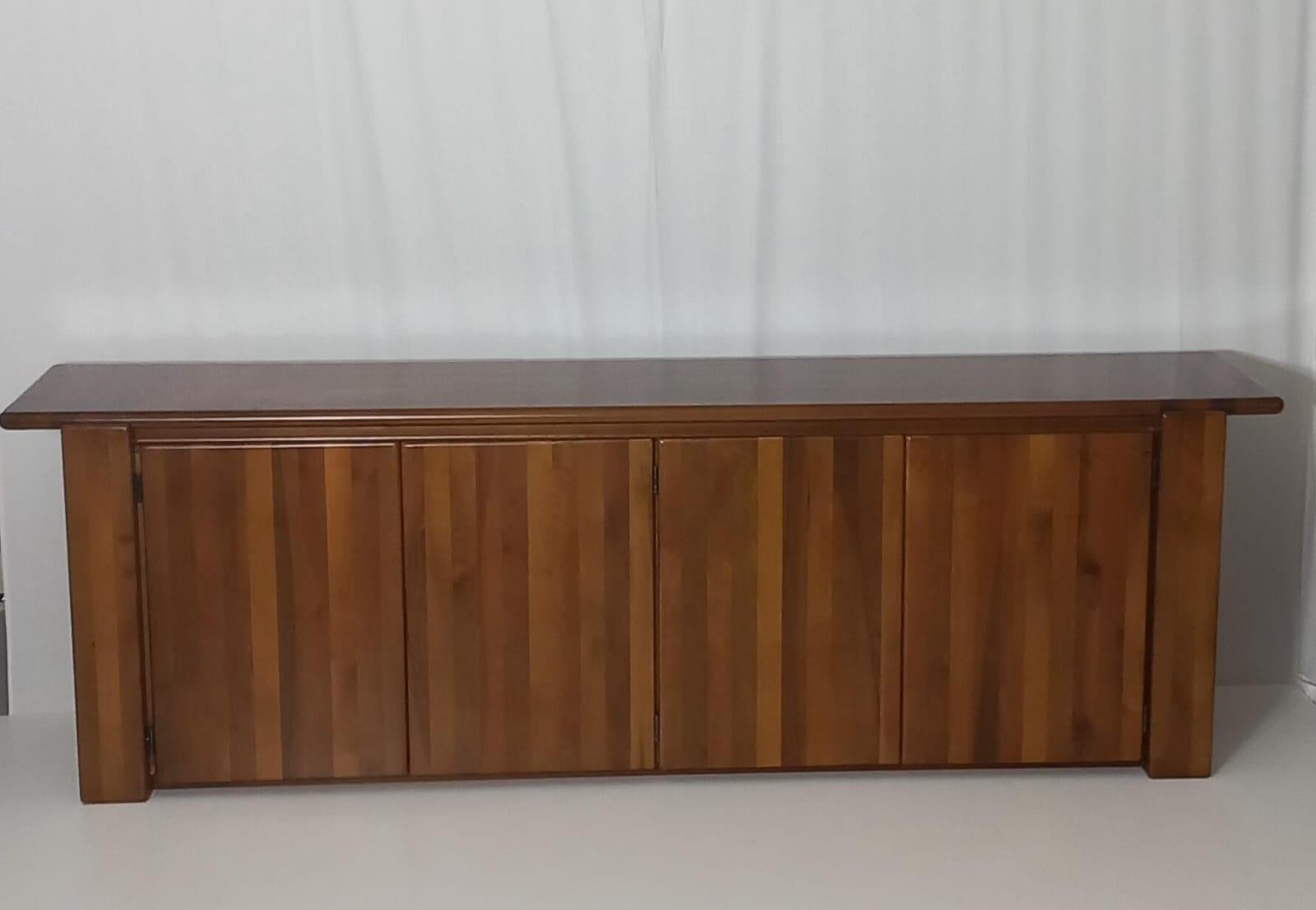 Add a touch of timeless elegance to your home with this mid-century walnut sideboard, created by famous architect and designer Mario Marenco and produced by renowned Italian furniture firm Mobilgirgi in the 1970s. Its simple lines capture the