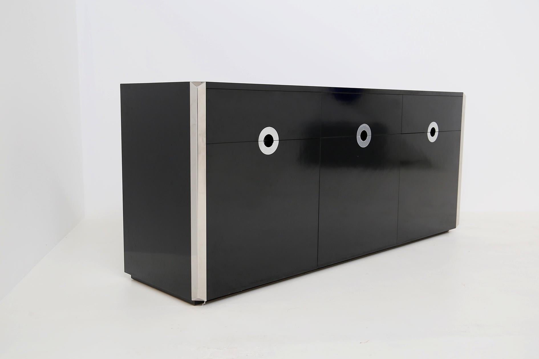 Elegant and sturdy sideboard designed by Willy Rizzo in 1970s. 
The sideboard was made for Mario Sabot. The sideboard has a sturdy structure in black lacquered wood. The peculiarity of the sideboard is its triangular steel profiles. Another