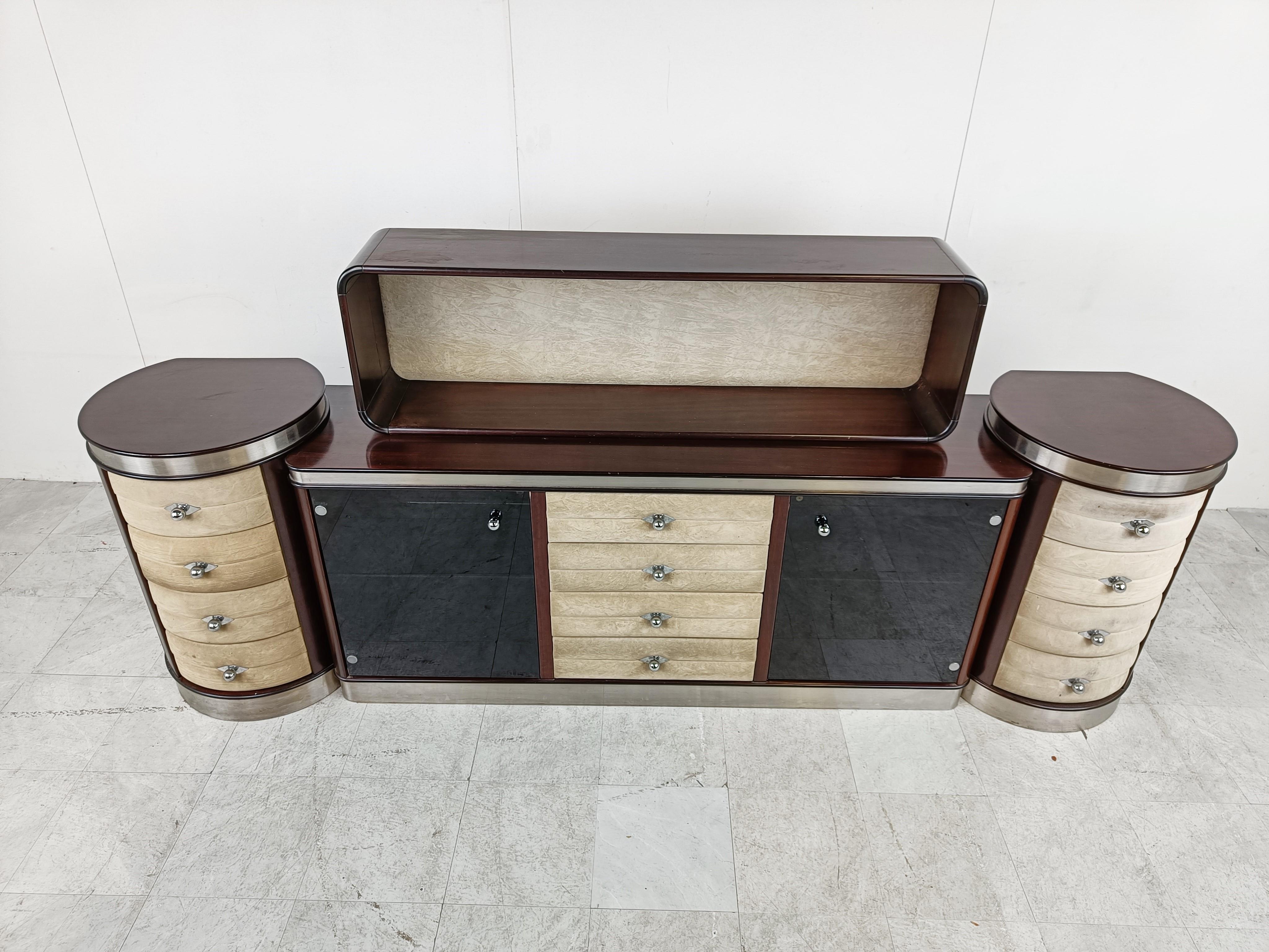 Exceptional sideboard made in italy in the 1970s.

This sideboard is made out of wood, aluminum, smoked glass doors and beige velvet.

The upper part is loose so you can decide to either use it or not. The sideboard was in fact used in a dining