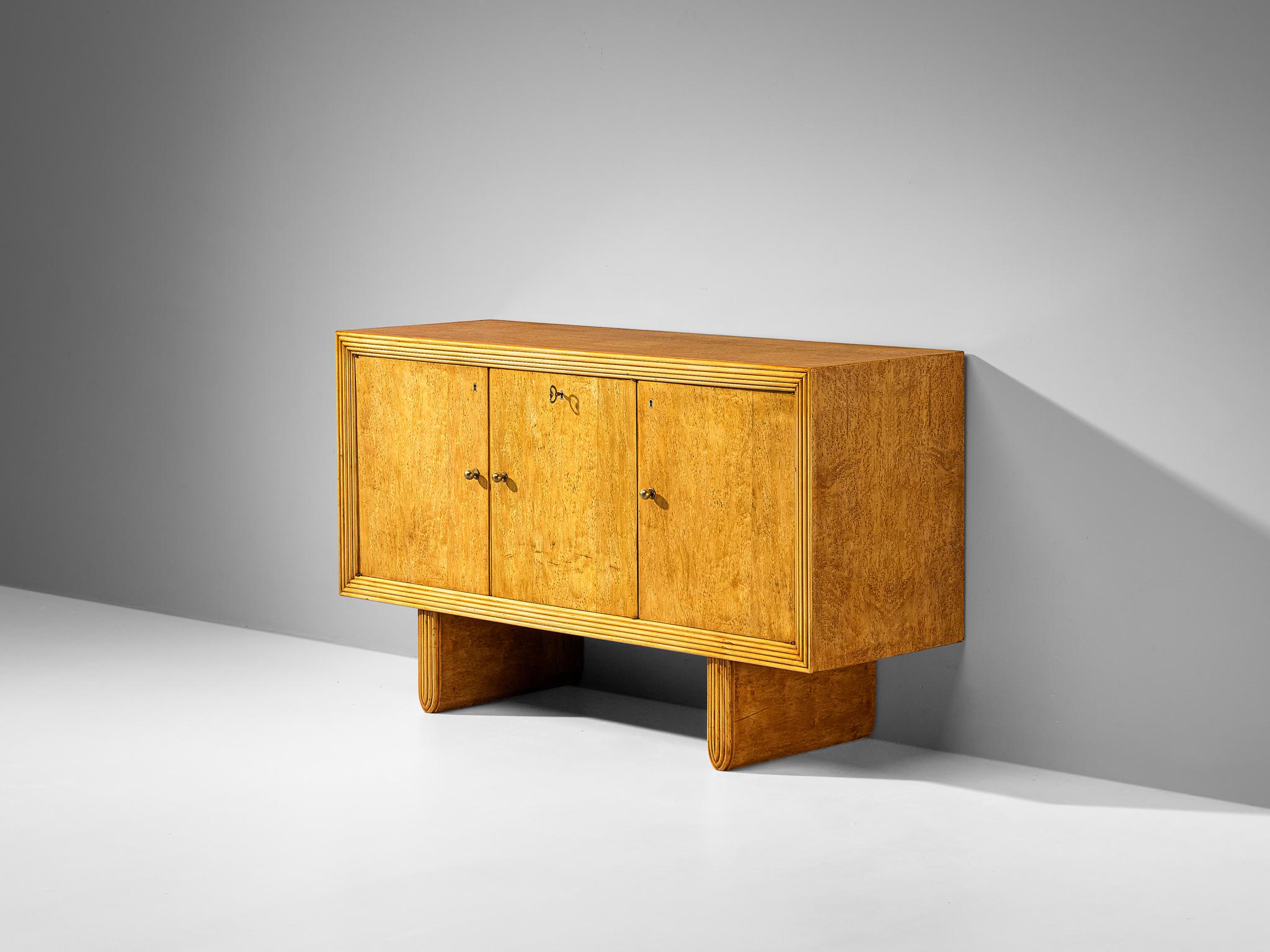 Sideboard, birdseye maple veneer, birch burl veneer, brass, Italy, 1950s

This truly exceptional sideboard is from Italy, showcasing its excellence in composition, material use, and intricate detailing. The rectangular-shaped corpus is framed by a