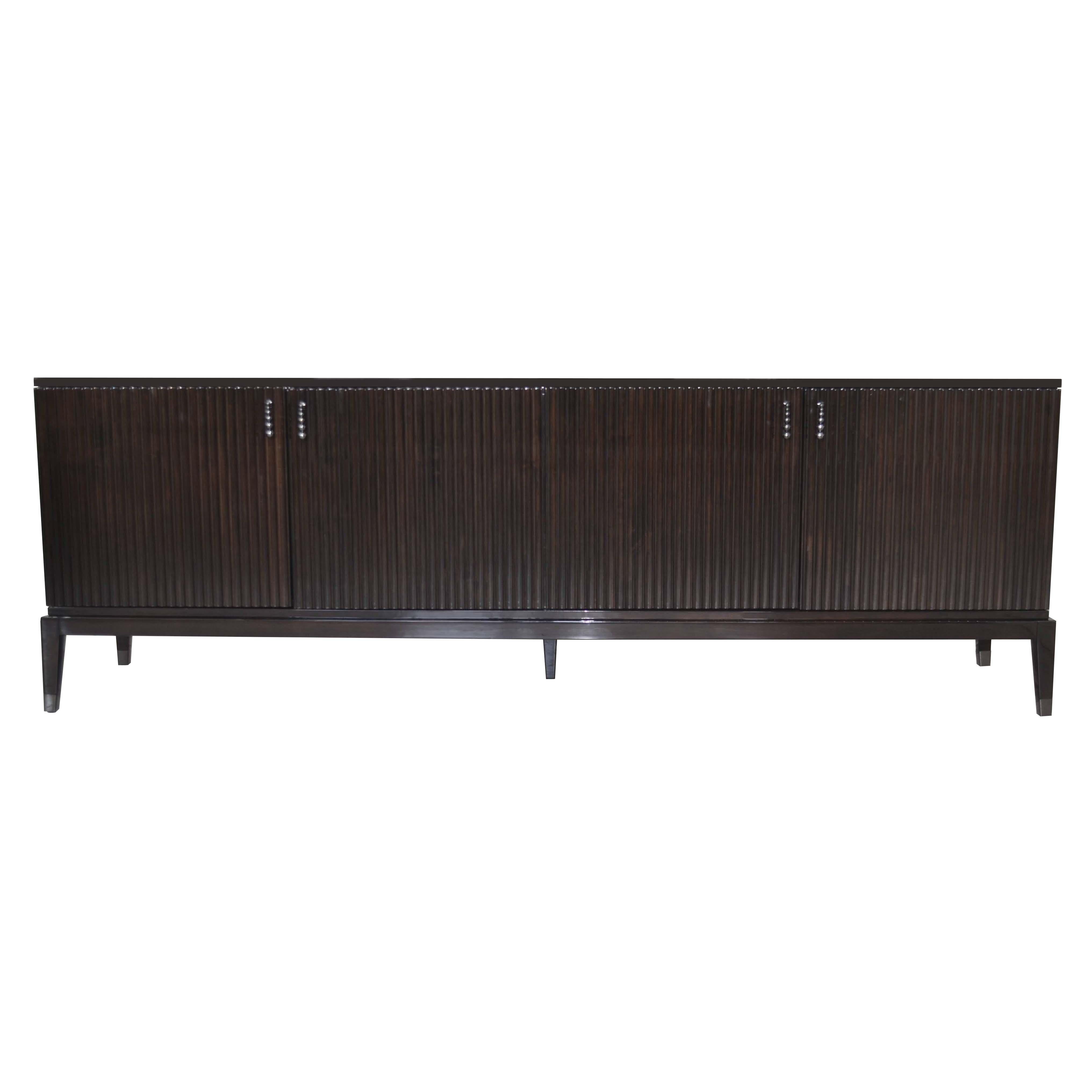 This sideboard featuring LED light inside, when at least one of the door is opened. Laquered in ebony brown is an outstanding piece in living room. Elegant and contemporary with four legs in Ebano Lucido Scuro. Also it has internal leather shelves.