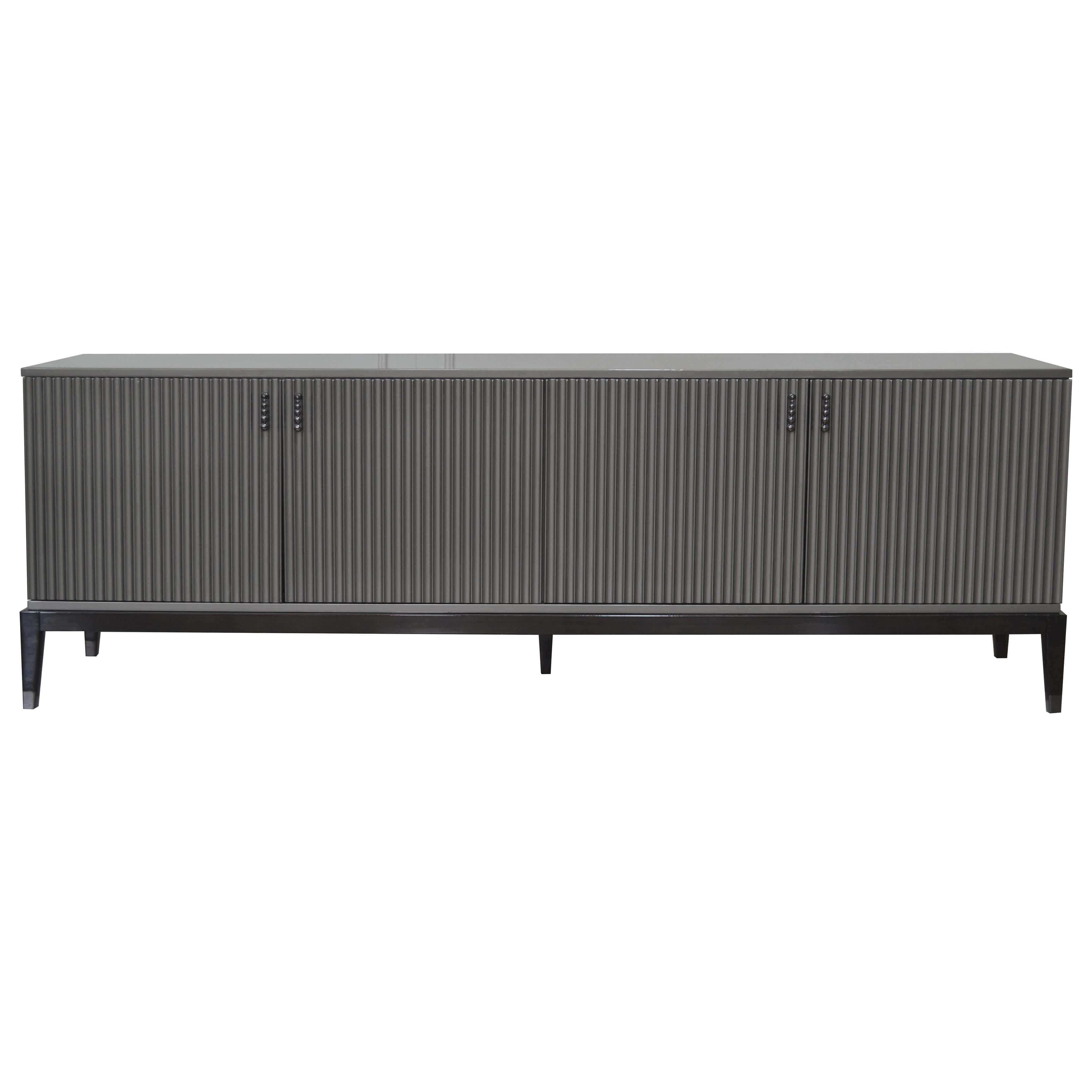 This sideboard featuring LED light inside, once at least one of the door is opened. Laquered in Gray high-gloss is an outstanding piece in living room. Elegant and contemporary with four legs in Ebano Lucido Scuro. Also it has internal leather