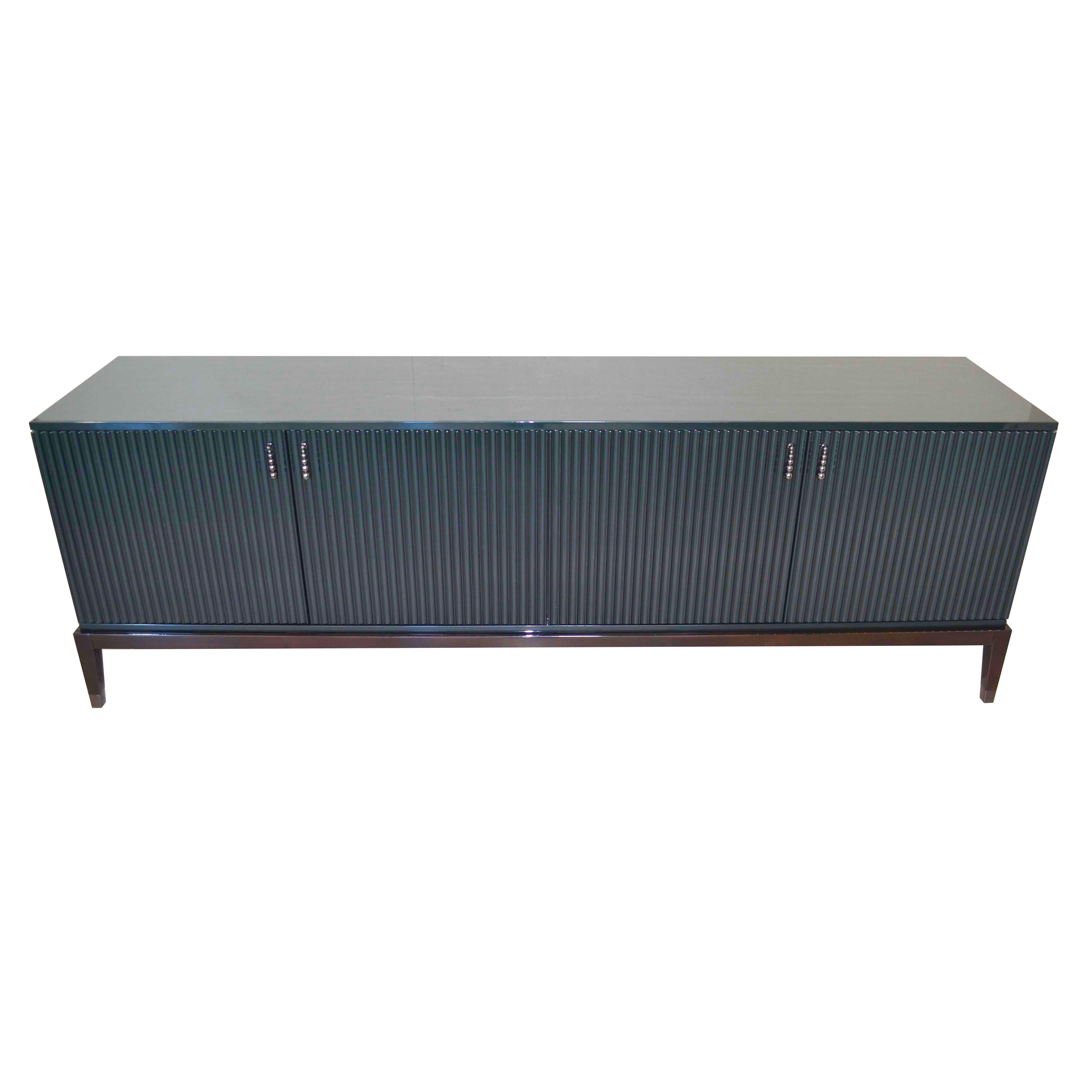 This sideboard featuring LED light inside, once at least one of the door is opened. Laquered in green smarald high-gloss is an outstanding piece in living room. Elegant and contemporary with four legs in Ebano Lucido Scuro. Also it has internal