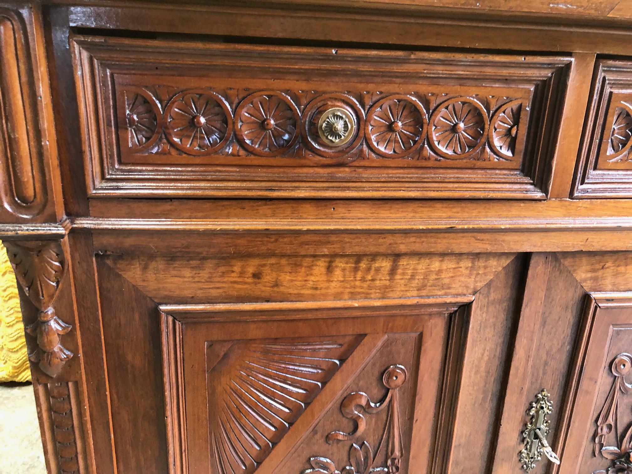 Original 1900 sideboard in hand-carved walnut, has solid wood parts and veneered parts.
Nice design and size.
Comes from an old country house in Buggiano area of Tuscany.
The paint is original in patina, honey amber color. 
As shown in the