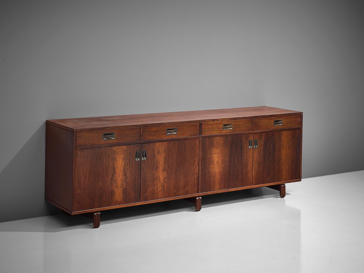 Stilldomus, sideboard, in rosewood and brass, Italy, 1950s.

This exquisitely finished credenza is executed in rosewood. Almost the whole of the interior and the back of this piece are finished with rosewood veneer too, making this a piece of high