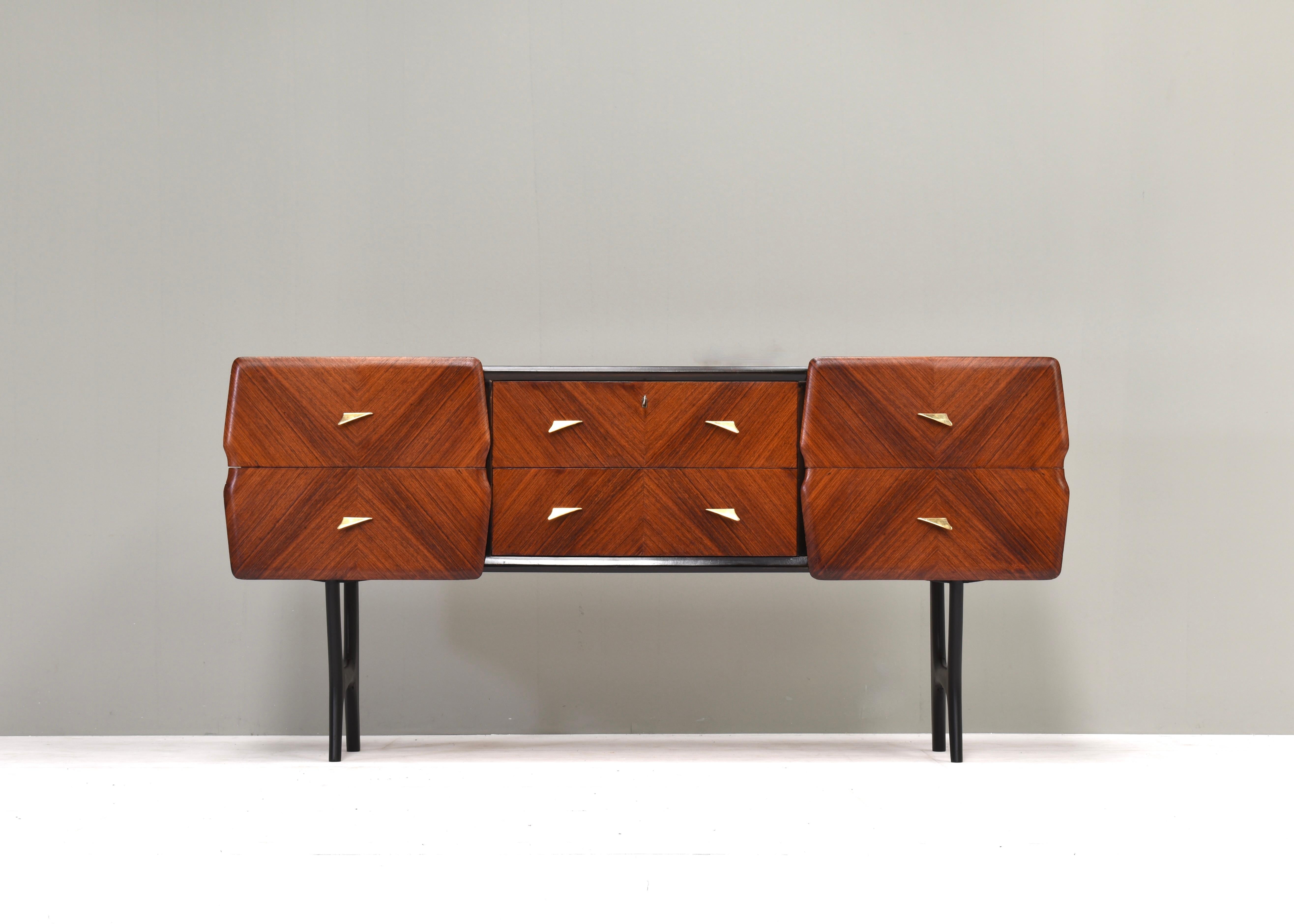 Sophisticated Italian walnut credenza by or in the style of Vittorio Dassi, Italy – circa 1950.

The credenza has been beautifully handcrafted with amazing details such as mirroring mosaic veneer finishings, handmade solid brass grips and a glass