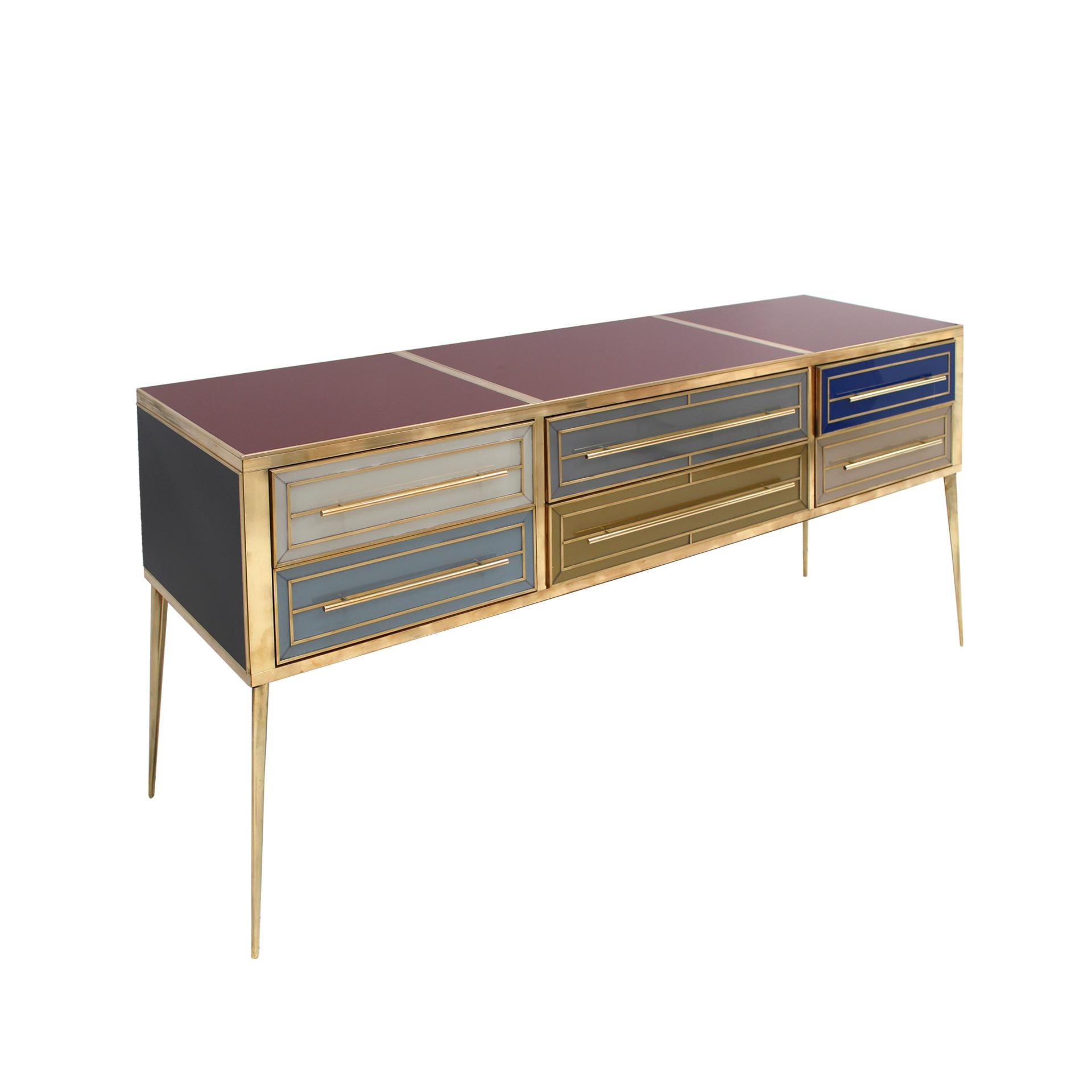 Sideboard composed of 6 drawers with an original structure from the 1950s made of solid wood and covered with colored glass. Handles, legs and profiles made of brass. Italy, 1950s.

Our main target is customer satisfaction, so we include in the