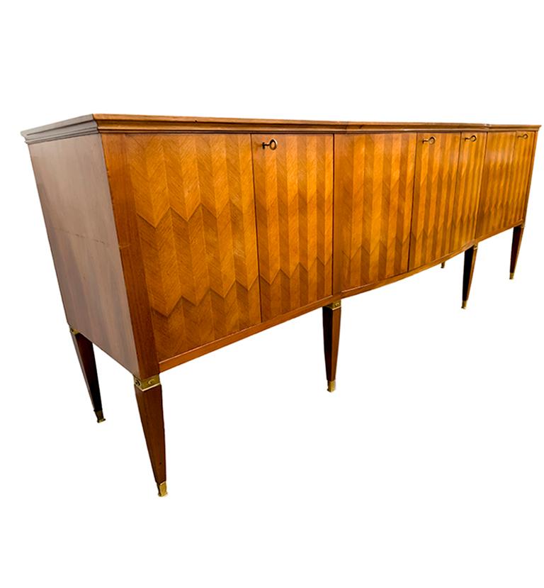 This Italian, Paolo Buffa server, with its magnificent chevron marquetry inlay is expertly crafted in the neoclassical style. The top is a reverse painted glass in hues of gray and light caramel colors. The enormous scale of the piece will create a