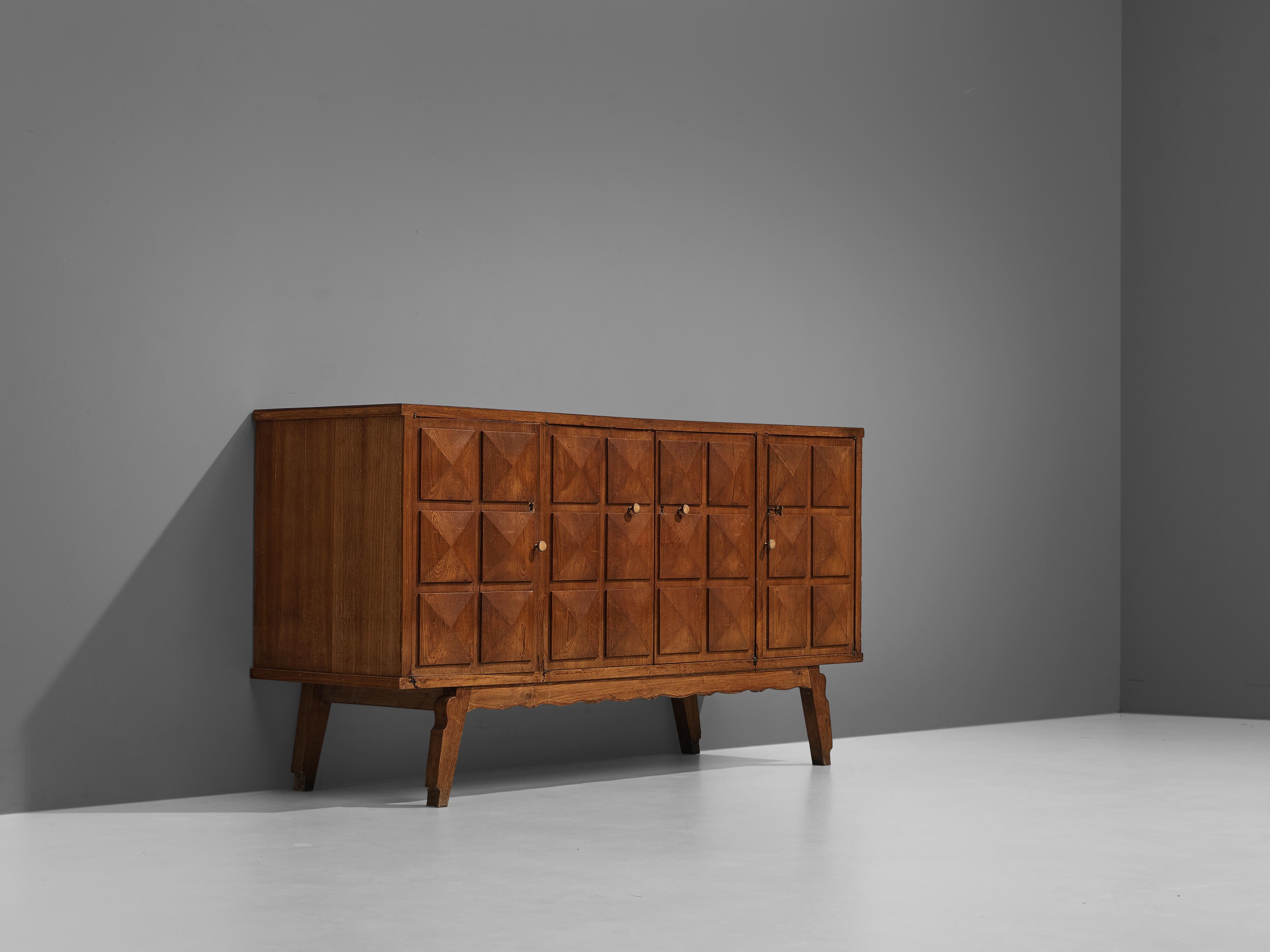 Sideboard, stained ash, brass, Italy, 1950s

Expressive sideboard in stained ash with graphical front. The designer of this Italian sideboard managed to make this functional sideboard a great visual pleasure. A combination of a pyramid-shaped relief