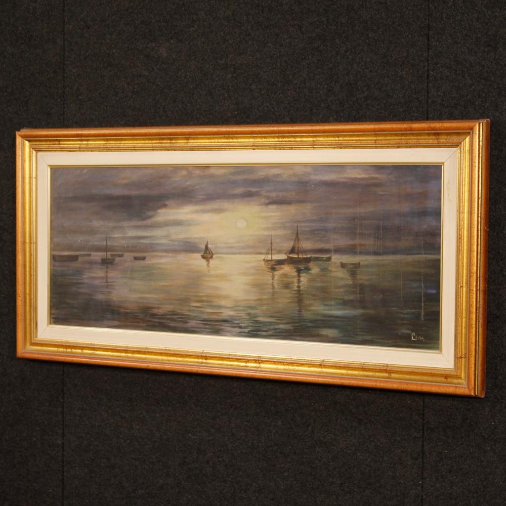 Italian painting from 20th century. Mixed-media on canvas (applied on cardboard) framework depicting nocturnal seascape with boats of good pictorial quality. Painting with a golden wooden frame, painted wooden passepartout and protective glass.
