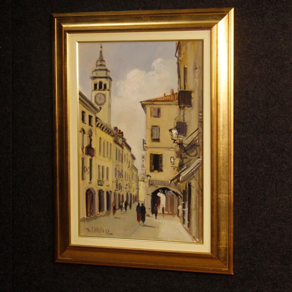 Italian painting from 20th century. Work oil on canvas depicting a view of a village in impressionist style. Framework signed lower left for antique dealers and collectors. Golden wooden frame with protective glass. In good condition with some small