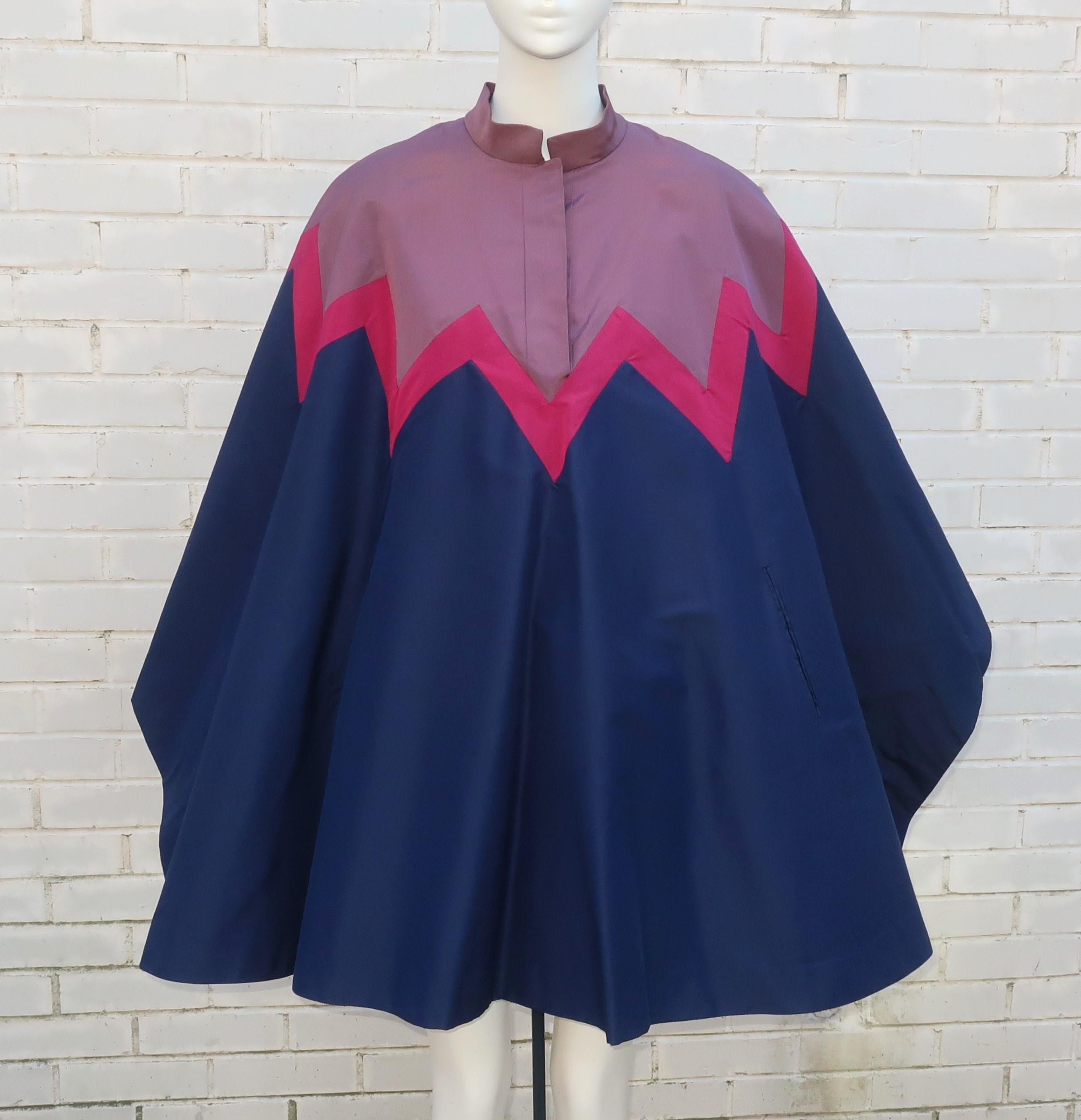 1970’s Italian silk faille cape with a luxurious sheared beaver fur lined interior.  The fur provides cozy warmth to this design while the silk outer is a fun combination of lilac mauve, magenta and blue with a chevron pattern.  The fur also sports