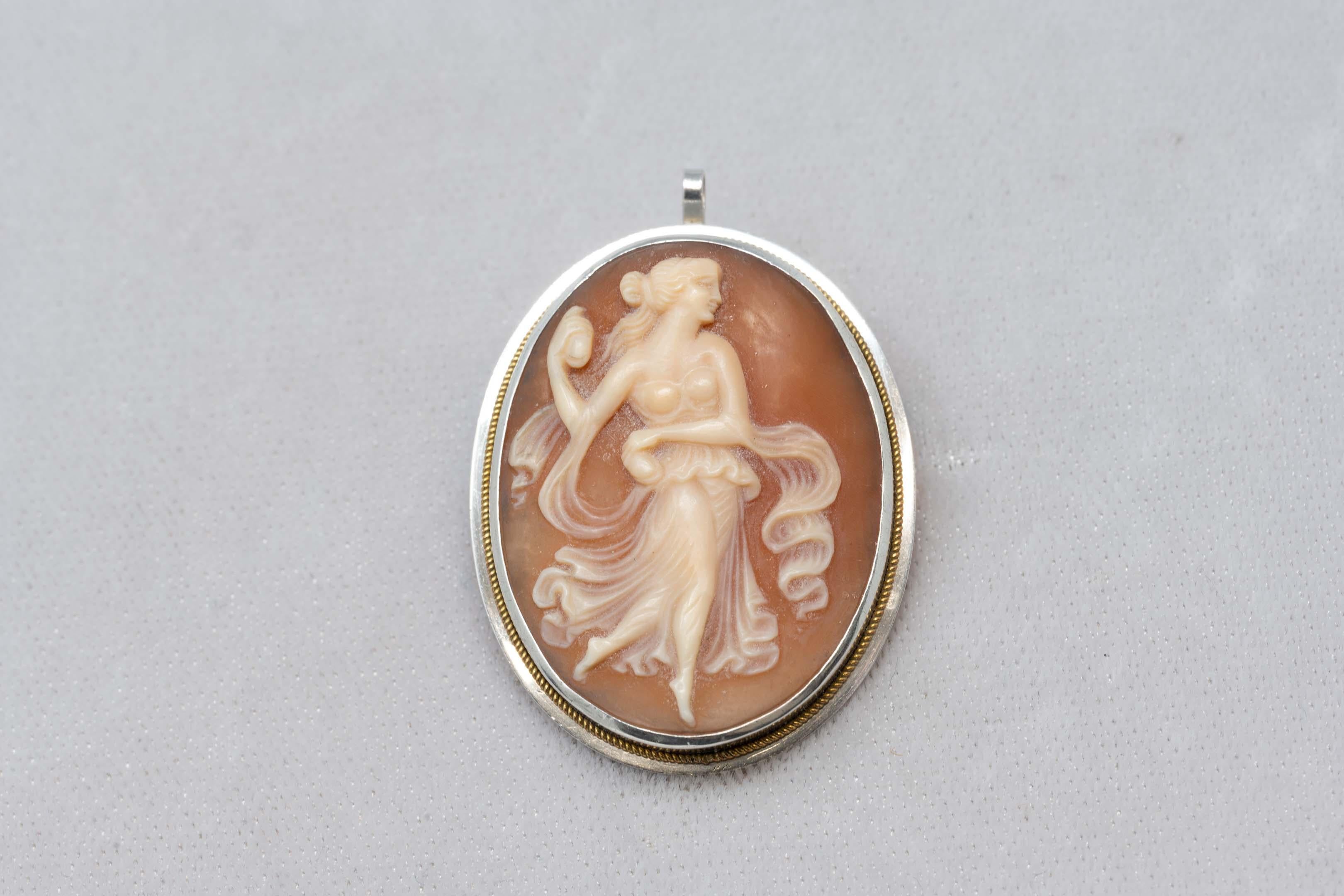 Italian solid silver and 14k gold shell cameo brooch pendant of a carved lady surrounded with gold bezel. Made in Italy, measures 42mm x 32mm, marked on the pin. 