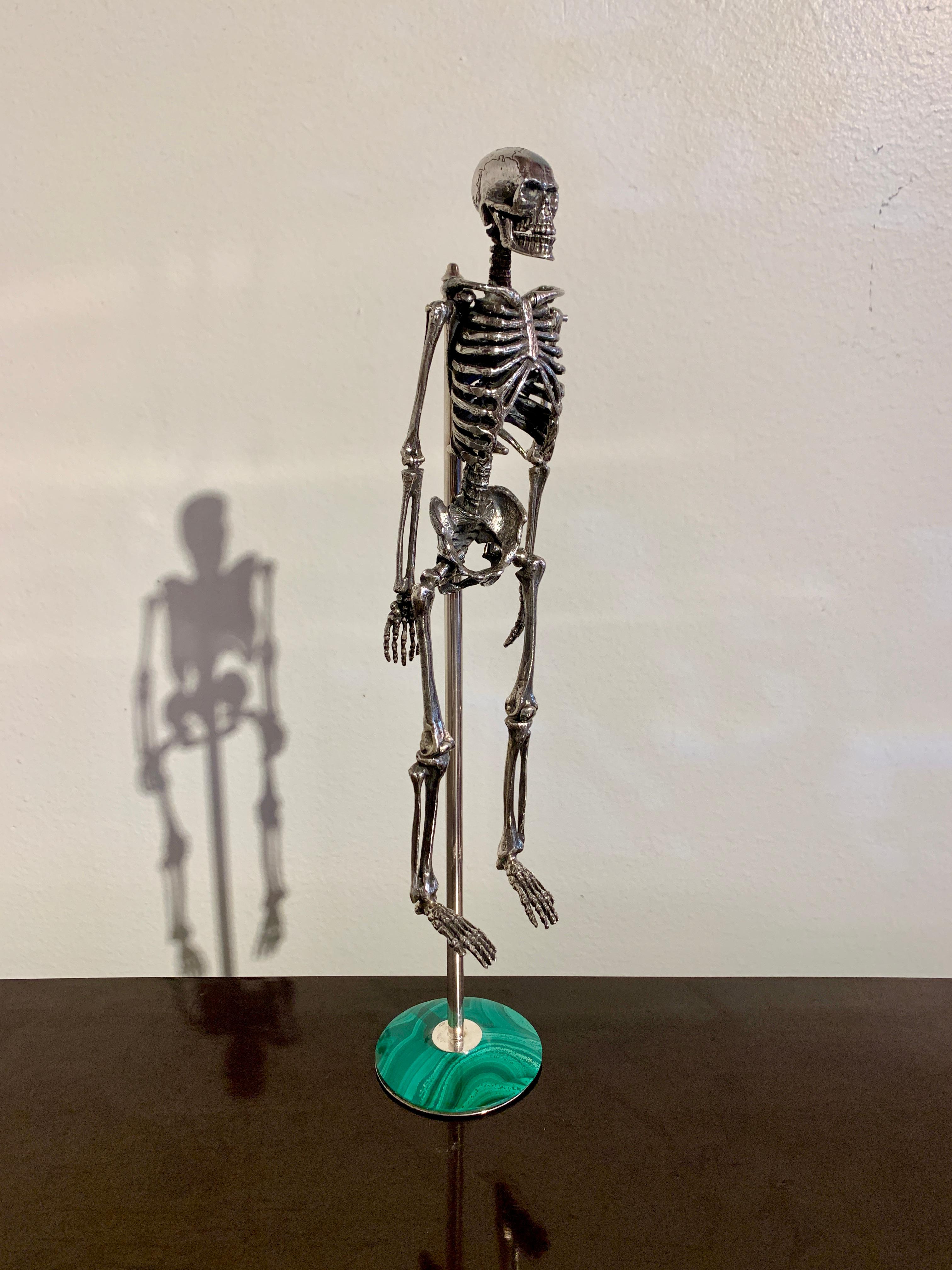 A fabulous Italian articulated model of a human skeleton on a silver and malachite stand, mid 20th century, Milan, Italy. 

The skeleton anatomically correct, with moving joints at the jaw, shoulders, elbows, hips and knees, allowing the skeleton