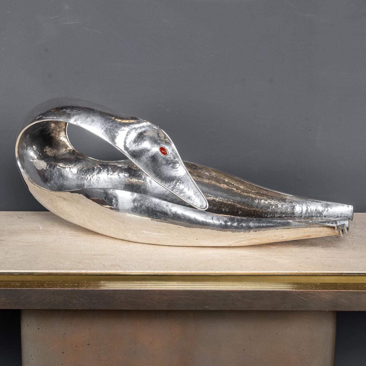 A stylish 20th Century Italian silver baguette tray in the form of a swan. Of a sleek, smooth form folds its neck back on itself revealing eyes made from carnelian. This modernist swan can hold bread and baguettes as a table centerpiece or as a