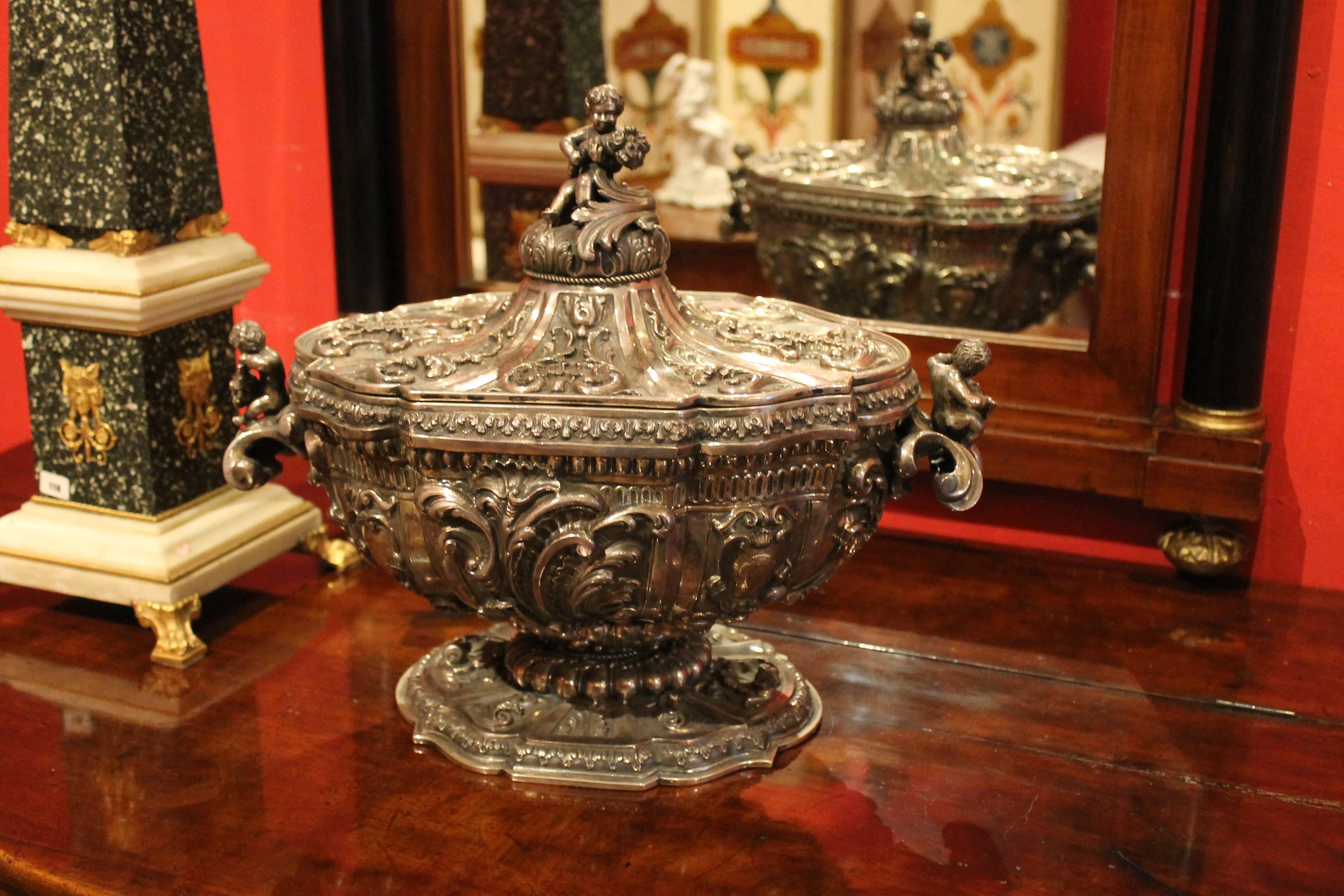 An exceedingly rare Roman silver bowl centrepiece richly chiseled and finely high relief embossed in the round. This silver tureen is a rich and one-of-a-kind work of art that displays the graceful and lavish Baroque details with intricate