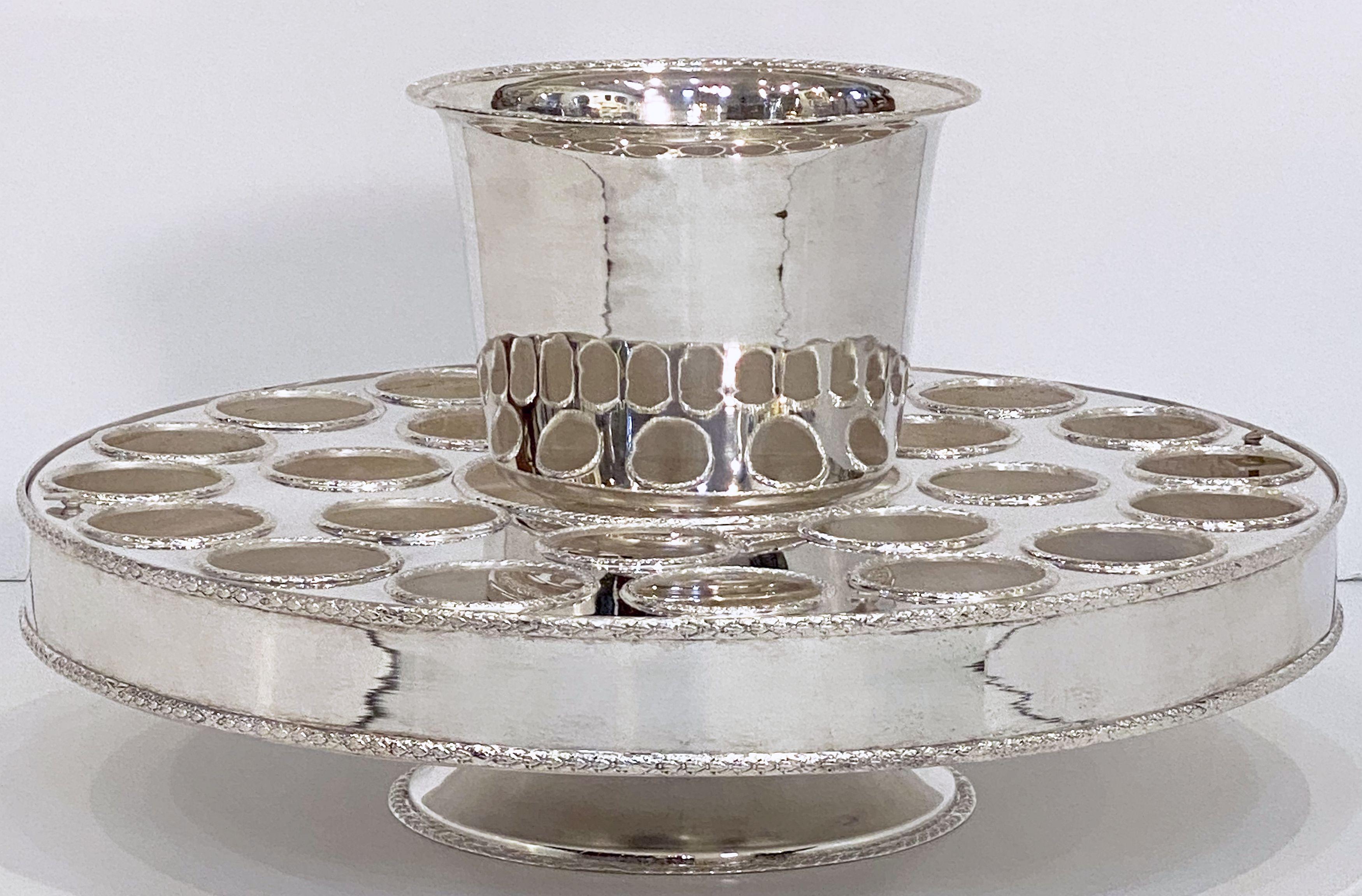 A beautiful Italian champagne service or presentation centerpiece, featuring a round revolving stand (or lazy susan) of fine plate silver, with fitted spaces for holding twenty-four champagne flutes and a removable champagne or wine cooler in the