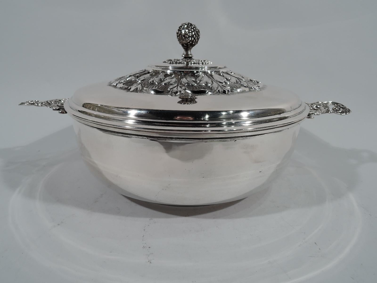 Italian 800 silver covered vegetable serving dish. Bowl has curved sides and inset foot ring. Handles with pierced scrolls and scallop shells mounted to sides. Raised cover with berry finial on delicately pierced mount in turn surrounded by bold