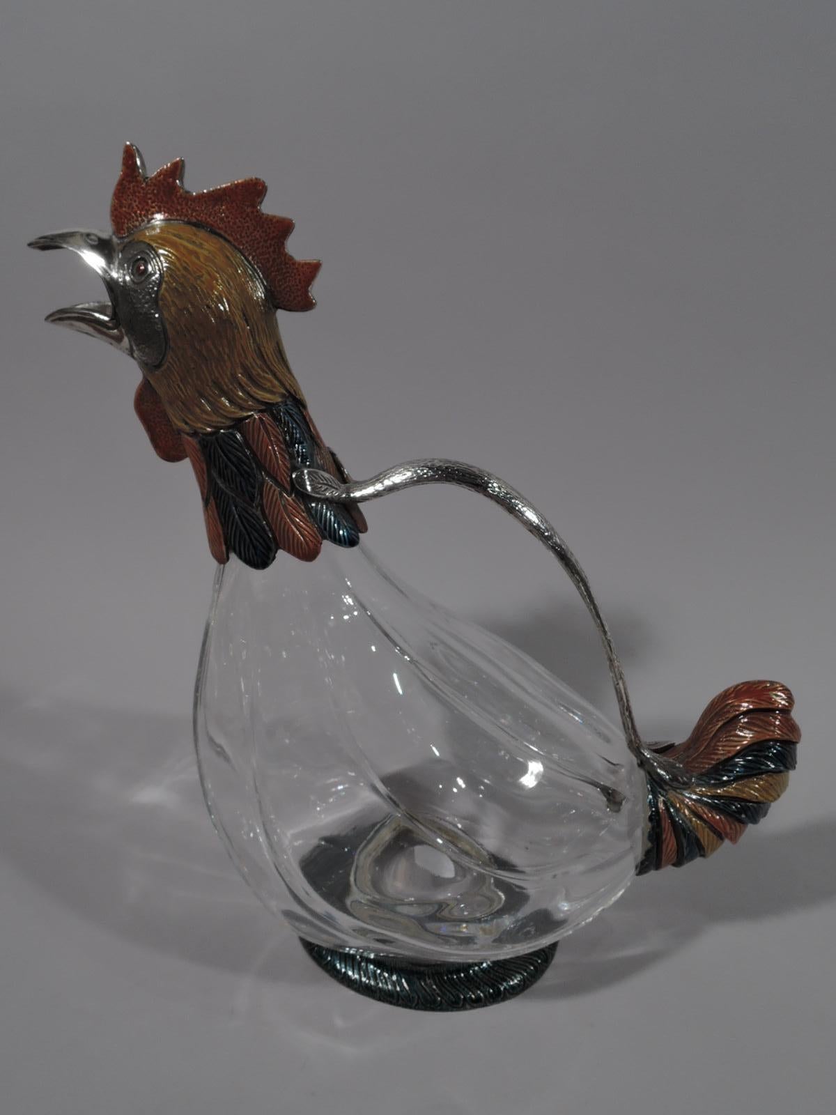 Modern glass and enameled sterling silver figural flamboyant fowl decanter. A rooster with clear glass body. Head and neck enameled sterling silver with striated and imbricated feathers, and cawing beak spout. Ruffled plume tail and round foot.