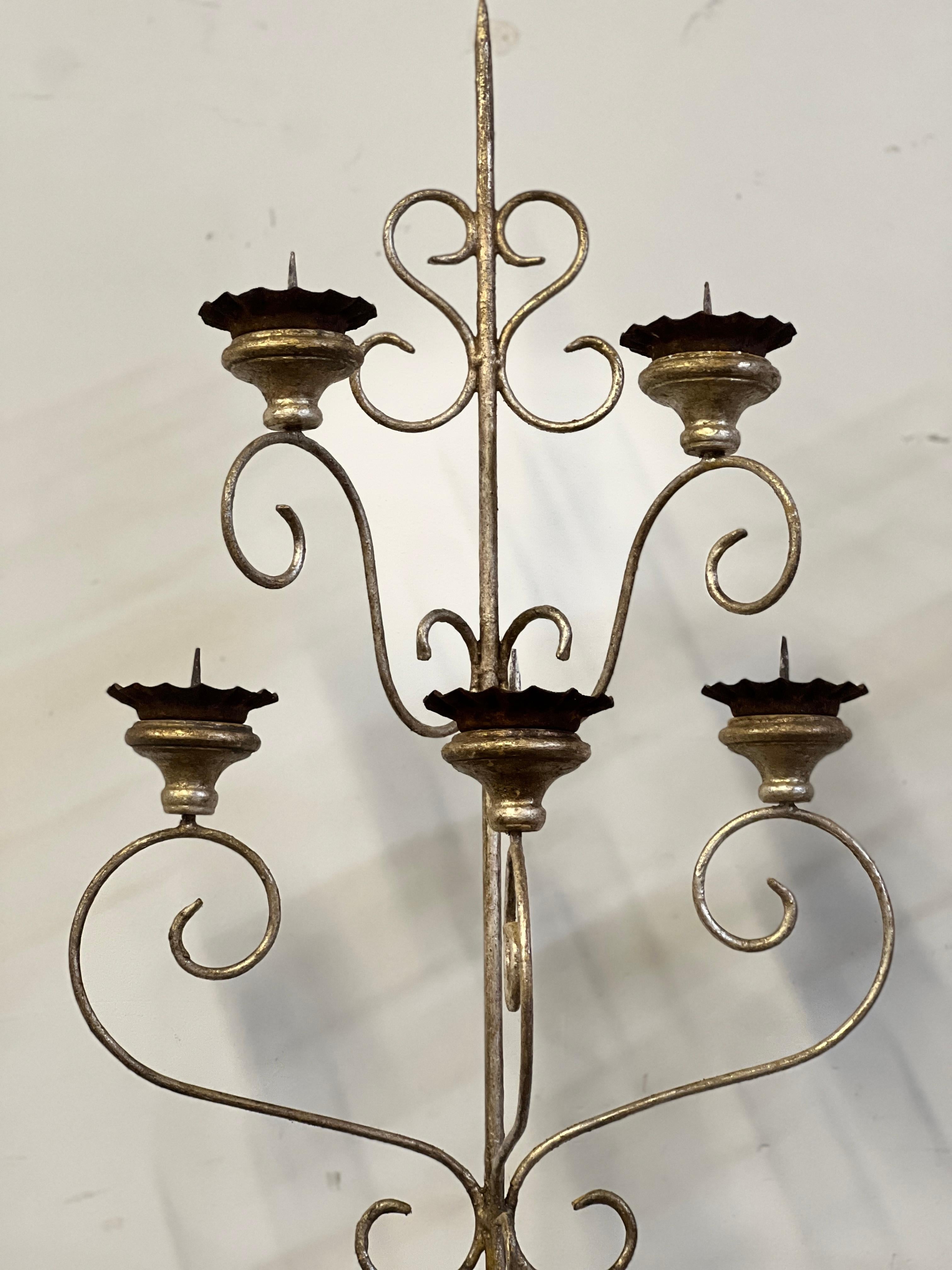 Unique and simple pair of silver gilt Italian 5 Arm Candle Wall Sconces that feature antique Italian bobeches. These are lightweight and are neutral toned making them perfect for many spaces. This pair comes with custom made backplates to help for
