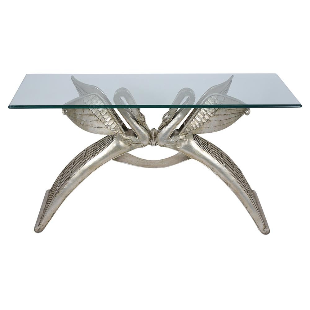 An extraordinary Italian sculpture console table is handcrafted out of metal with a silver-gilt finish and is newly restored by our team of craftsmen. This console features a unique swan sculptures base and comes with a 1/2 inch thick glass with of