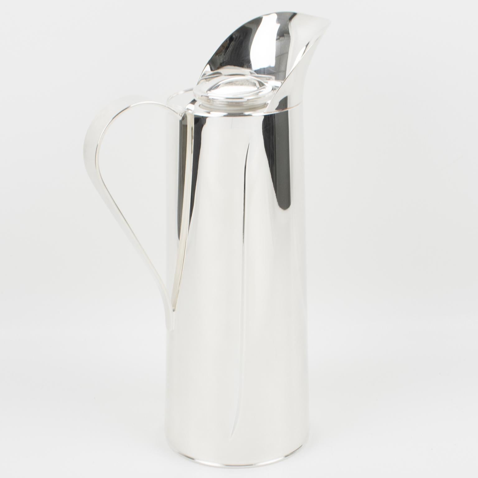 This is an elegant Italian silver plate barware bar thermos or insulated decanter, carafe, or coffee jug. With its sleek and modernist design, this pitcher is made from silver plate metal and features a rounded shape with a large handle and a carved