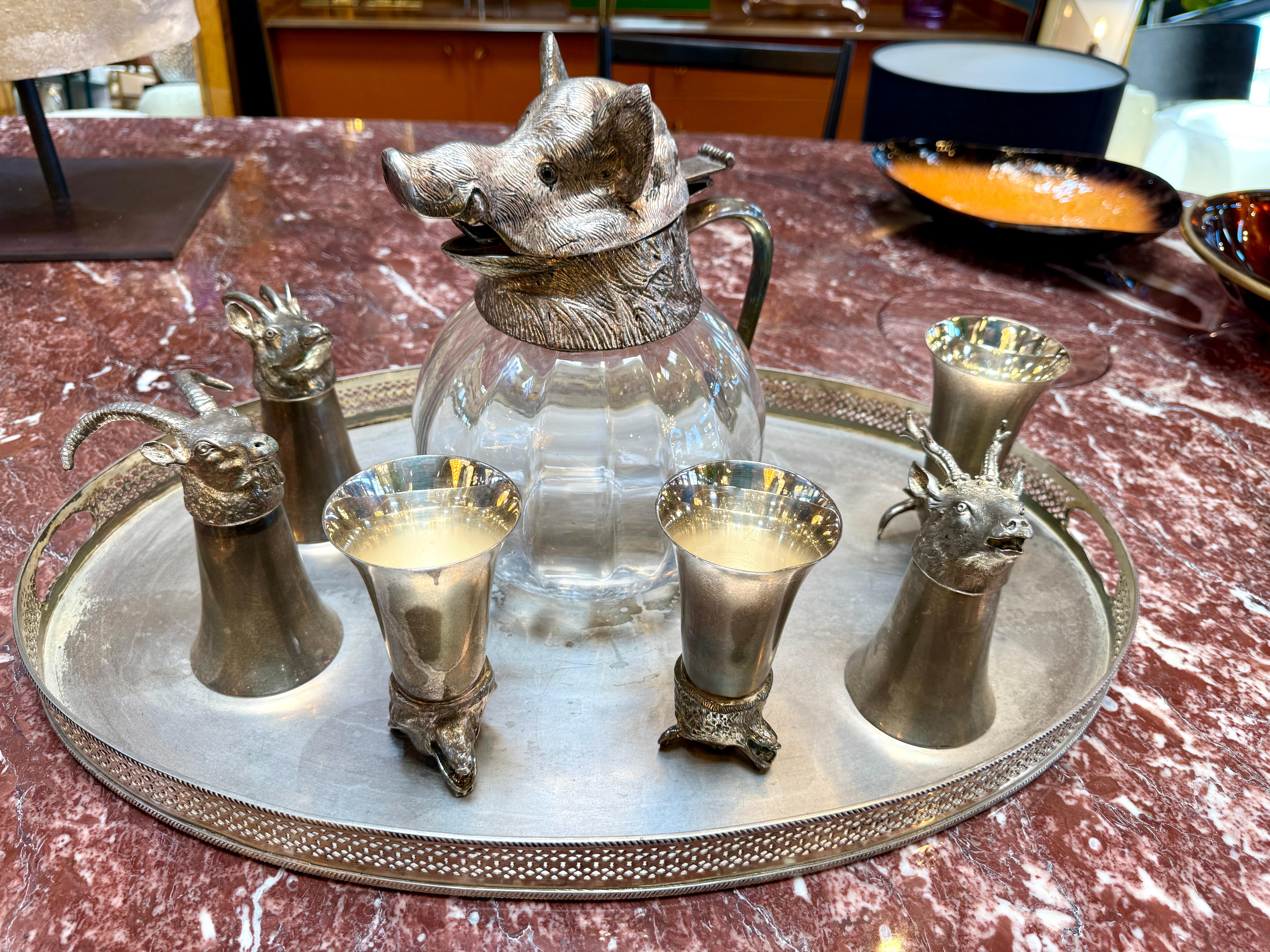 Whimsical yet refined Italian barware set by Valenti, 1960s. The rare set features a sculptural glass decanter topped with a finely cast silver-plated boar’s head lid, accompanied by five goblets, each adorned with detailed animal heads including
