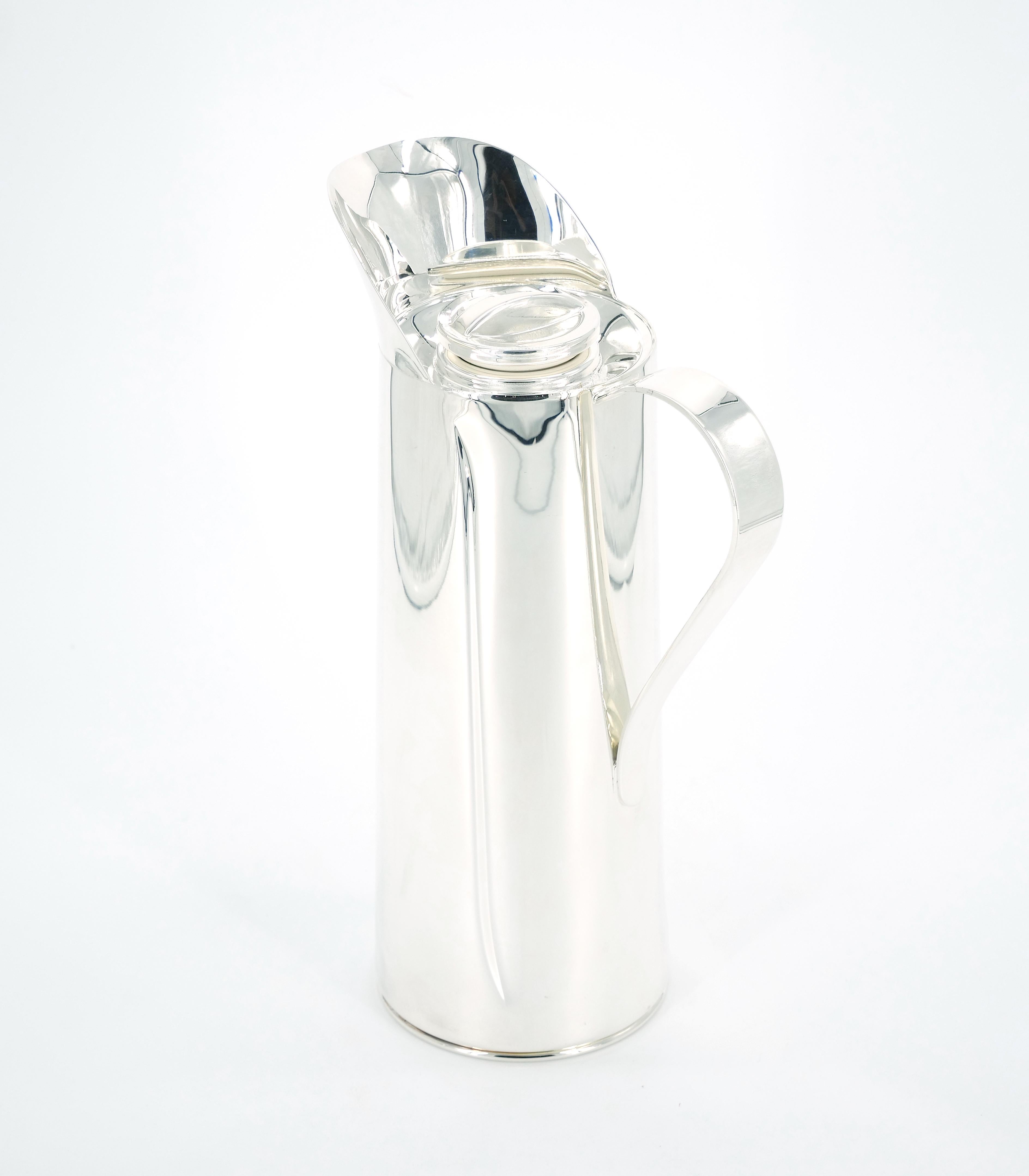 Indulge in the perfect blend of style and functionality with our Italian Silver Plated Insulated Interior Hot/Cold Beverage Thermos. This sophisticated thermos boasts an Art Deco-inspired design characterized by clean lines, a one-side handle for