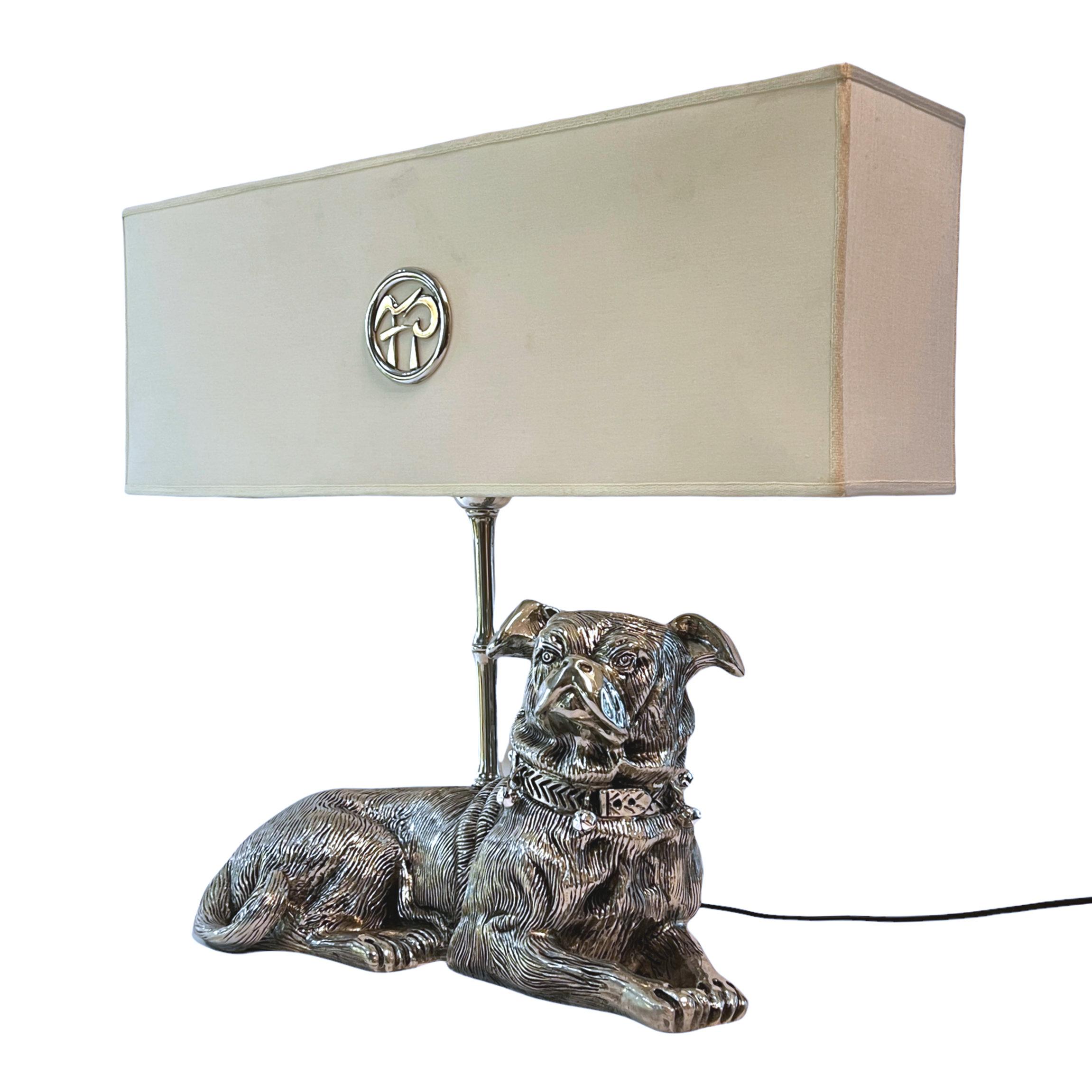 Our unique Italian silverplated pewter lamp depicts a seated pug is in excellent condition. Lamp with original shade measures 24.5 in wide and 20 in tall and is in very good condition, with some areas of very light soiling, hardly noticeable. The
