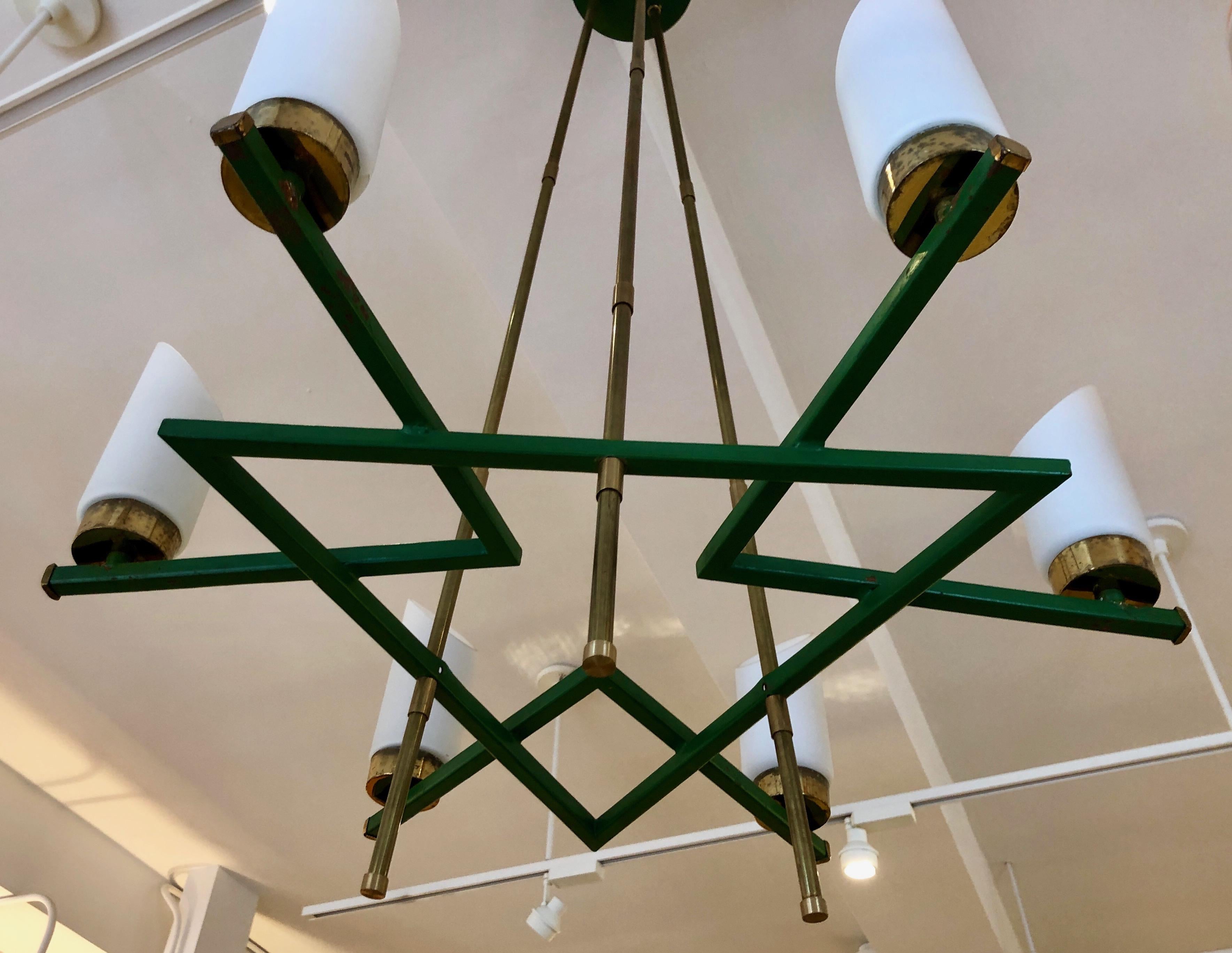 Chic, architectural design in brass, glass and enameled metal. Six upright lights sit on a green metal grid that is suspended by three brass rods.