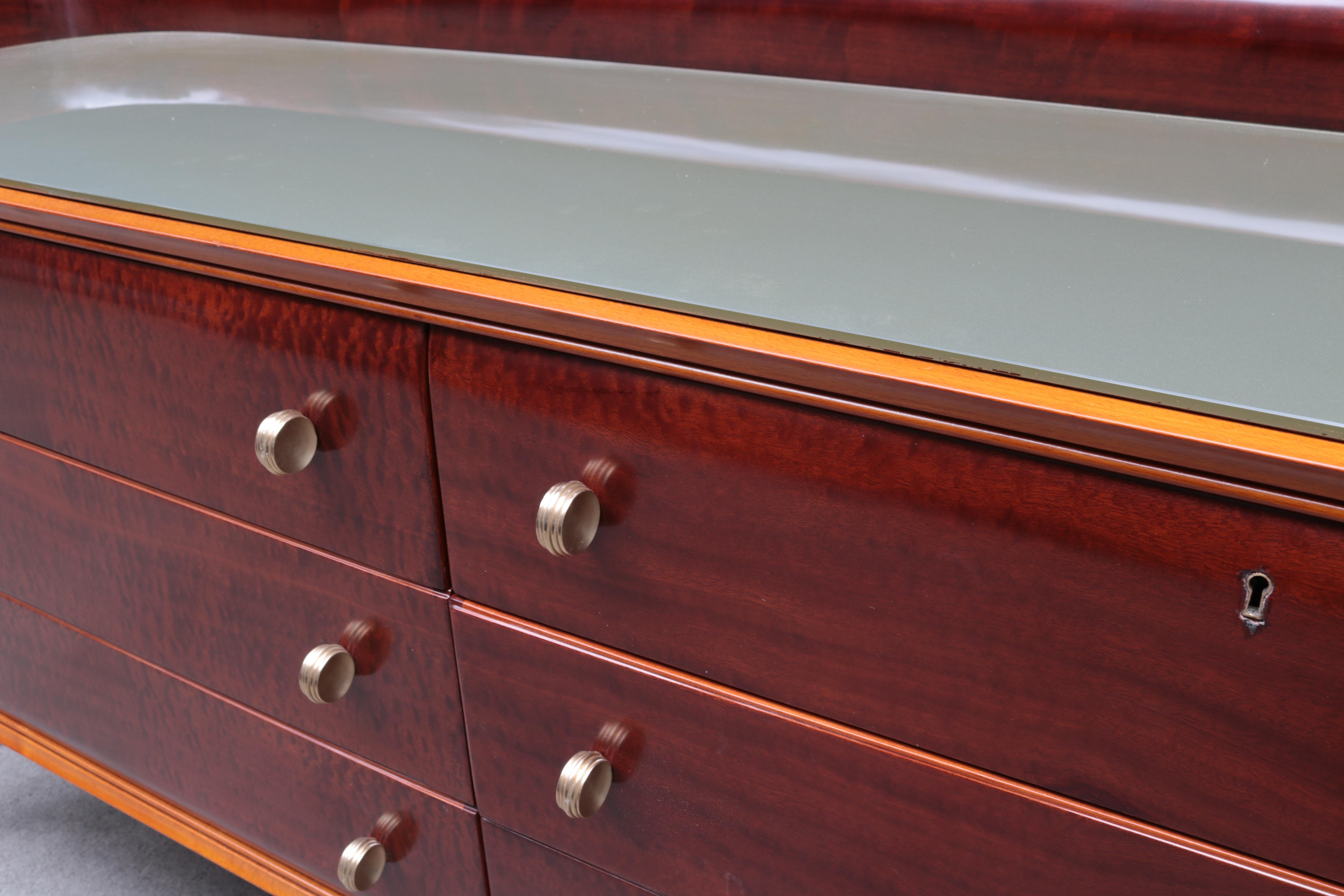 A fine Italian six-drawer commode.
Mahogany with pearwood trim, fruitwood inlays,
patinated brass pulls and sabots and glass top.
 