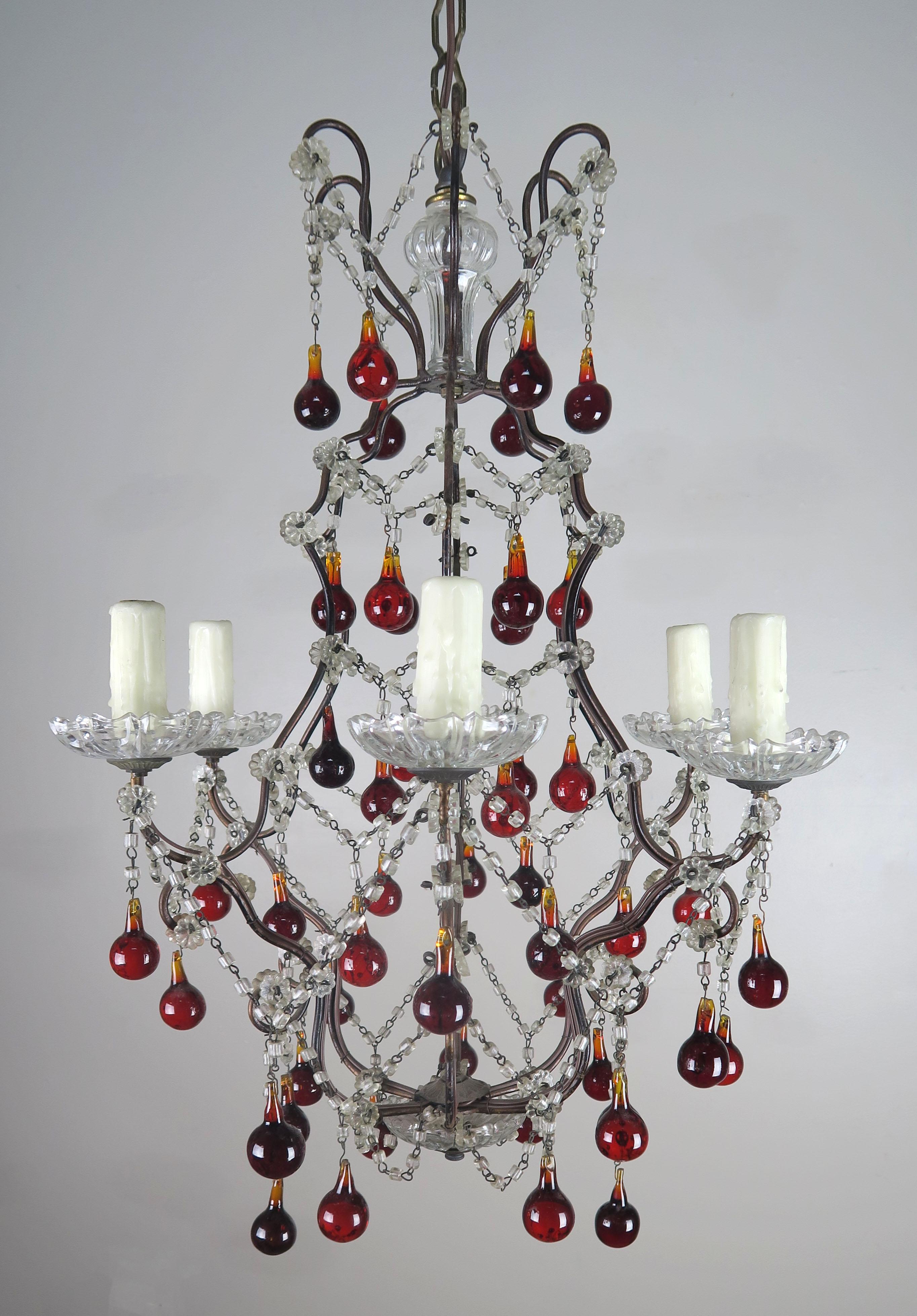 Italian 1930s macaroni beaded six-light chandelier adorned with vibrant crimson colored drops. Clear crystal bobeches. The fixture is newly rewired with drip wax candle covers and includes chain and canopy.