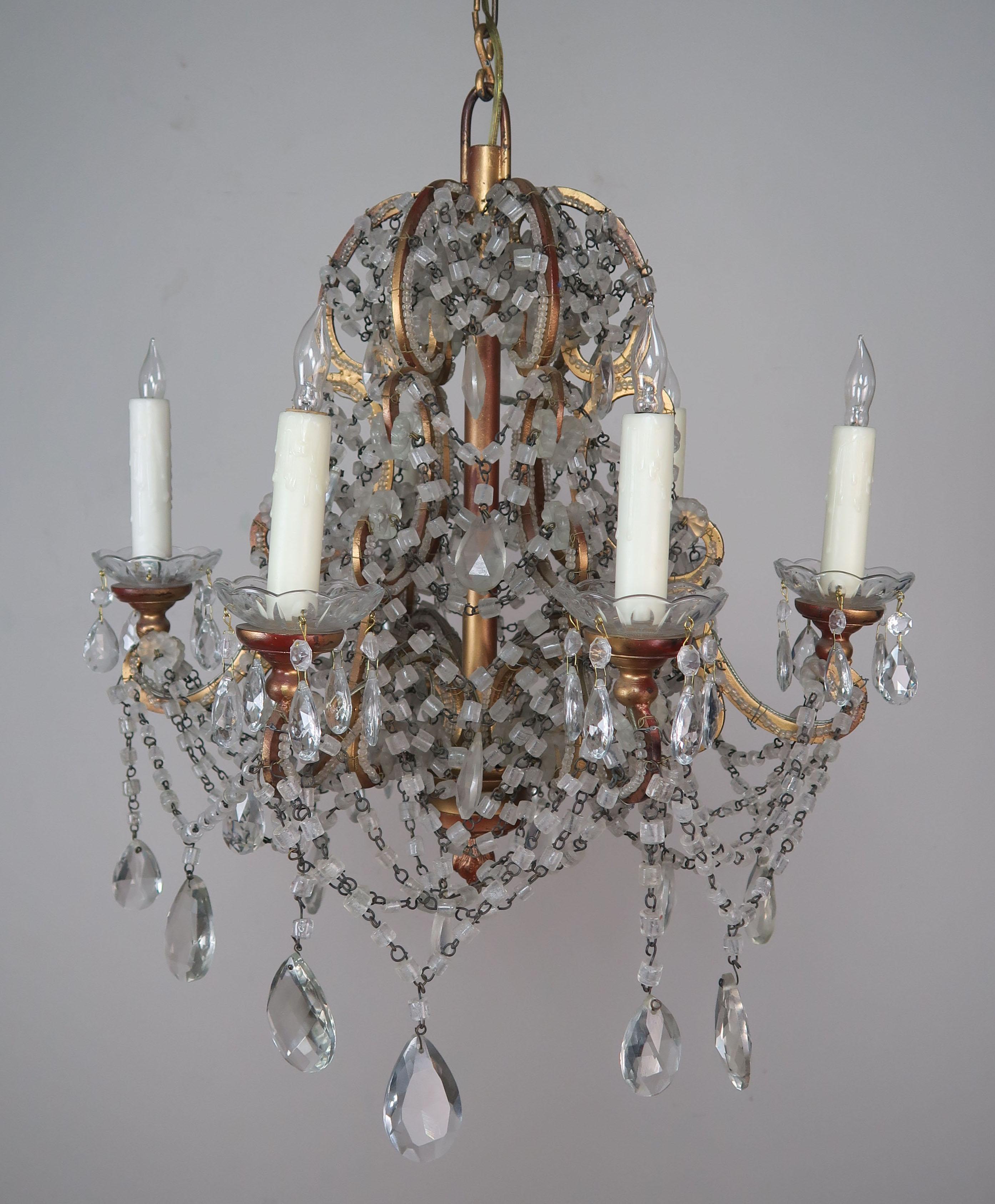 Italian six-light macaroni beaded crystal chandelier with gilt metal frame. The fixture has been newly rewired with drip wax candle covers and includes chain and canopy.