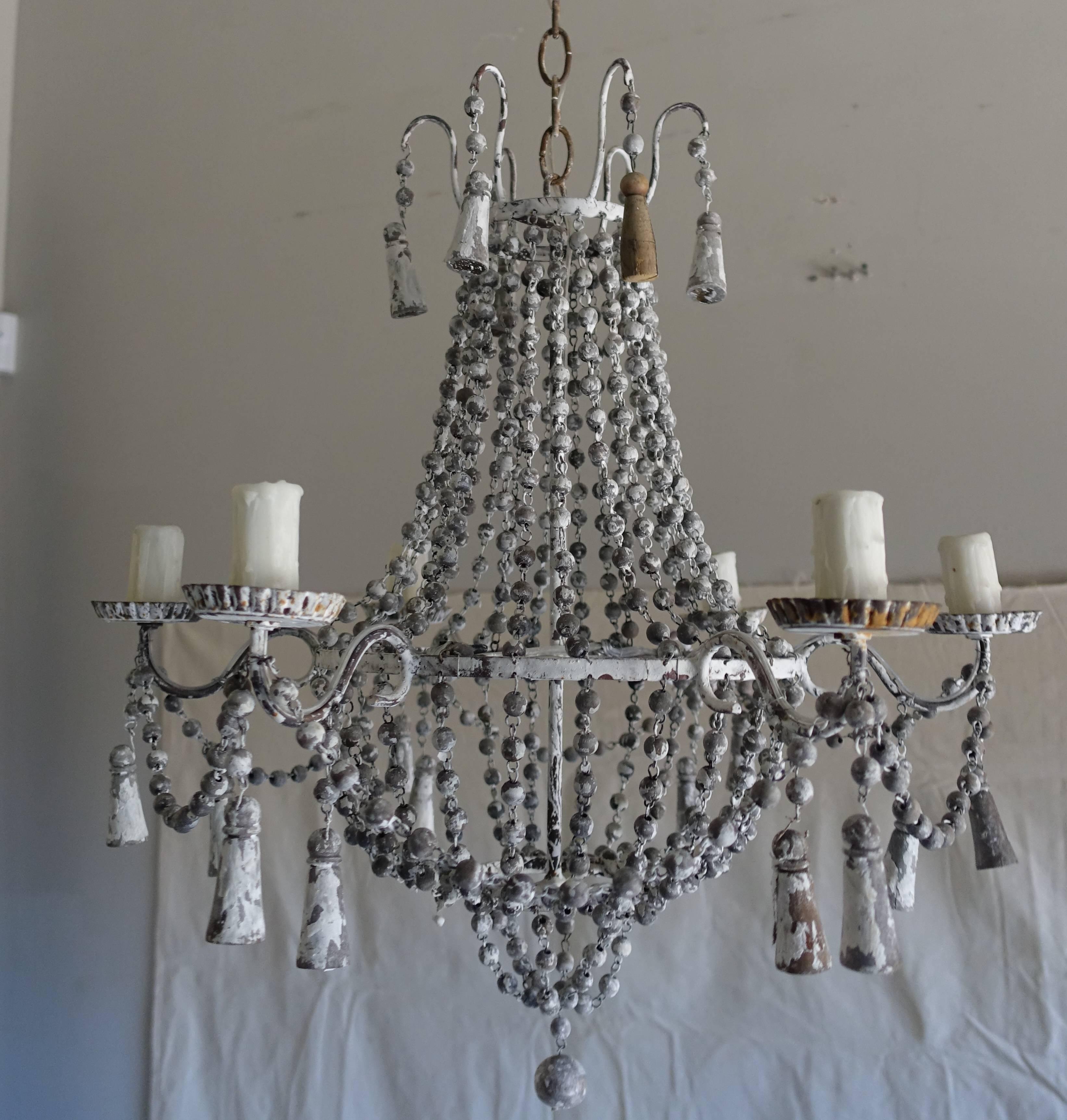 Italian six-light painted wood beaded chandelier with wood tassels throughout. Newly rewired with drip wax candle covers. Includes chain and canopy-ready to install.