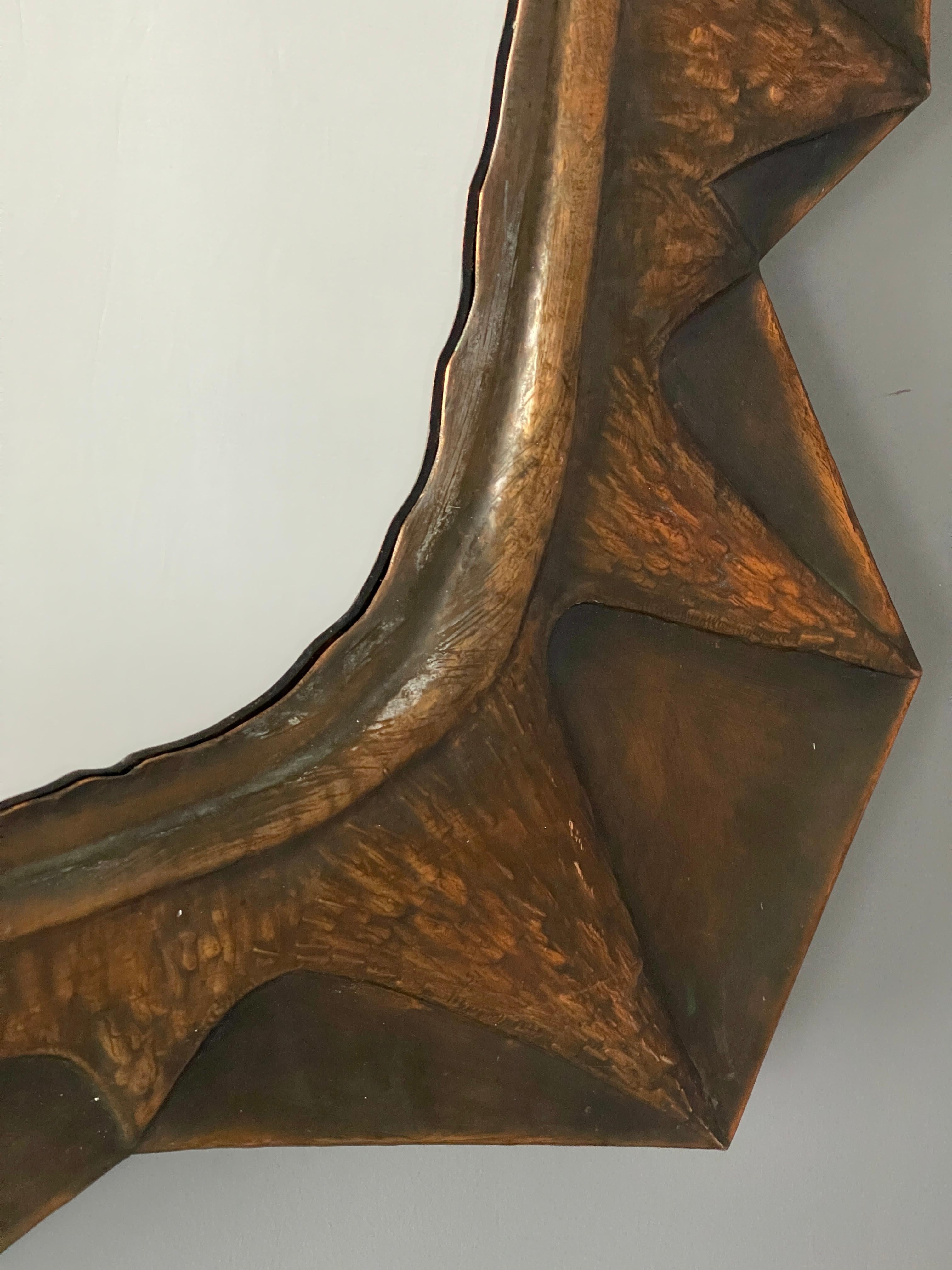 A sizable and sculptural freeform wall mirror, designed and produced in Italy, 1940s-1950s. Features a patinated copper mirror.

Other designers of the period include Gio Ponti, Fontana Arte, Line Vautrin, Francois-Xavier and Claude Lalanne, and