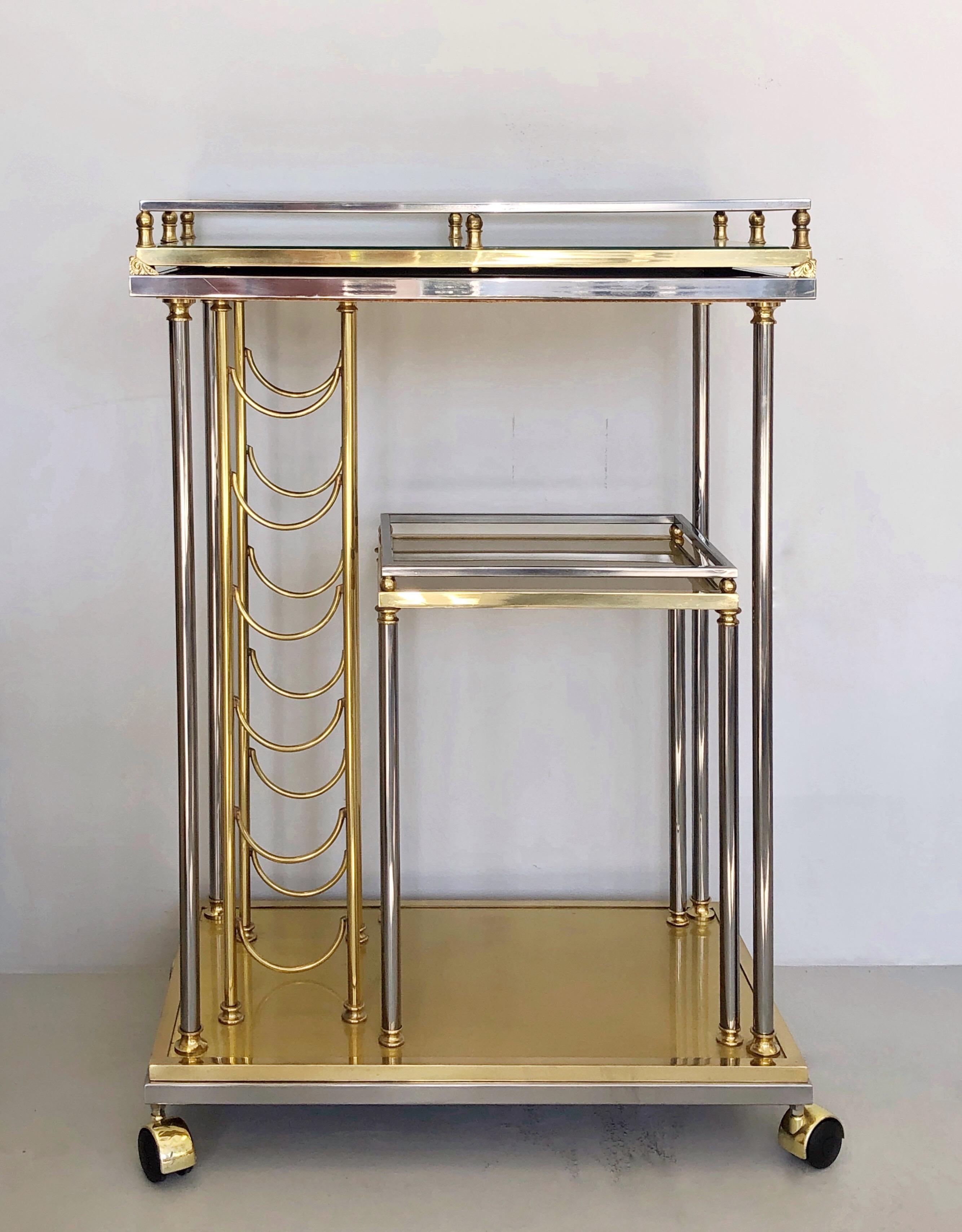 Quite unique bar cart or trolley. It is brass with some nickel accents. It has a seldom seen slender profile, and a removable tray. Extremely well crafted.