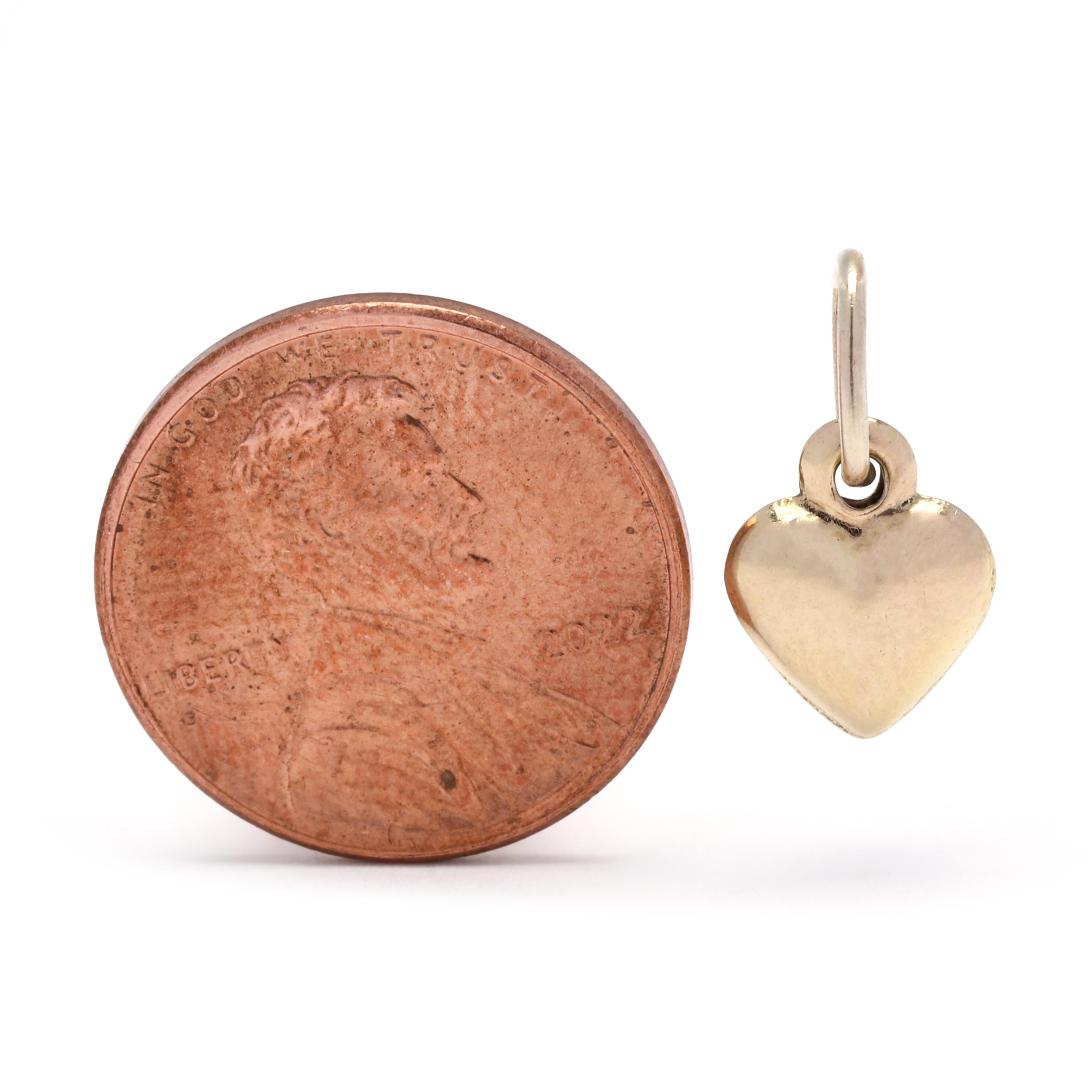 This beautiful 5/8 inch Italian small gold heart charm is crafted from 10K yellow gold and has a classic puff heart design. It is the perfect addition to any charm bracelet, necklace, or other jewelry piece. The timeless and elegant design of this