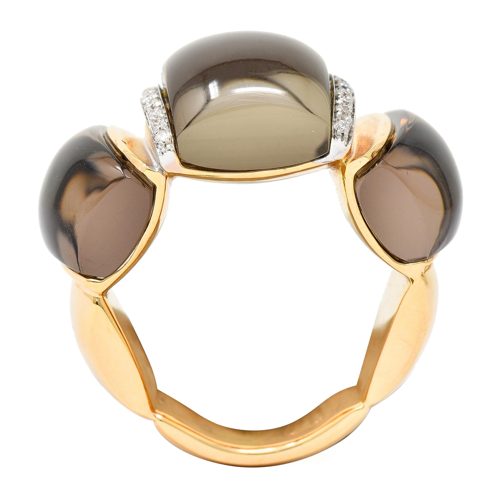 Deeply fluted band ring features three cushion cabochons of smokey quartz. Measuring approximately 16.5 x 10.8 mm to 15.0 x 8.5 mm. Very well matched, eye clean, and light brown in color. Cabochons are separated by white gold bars accented by round
