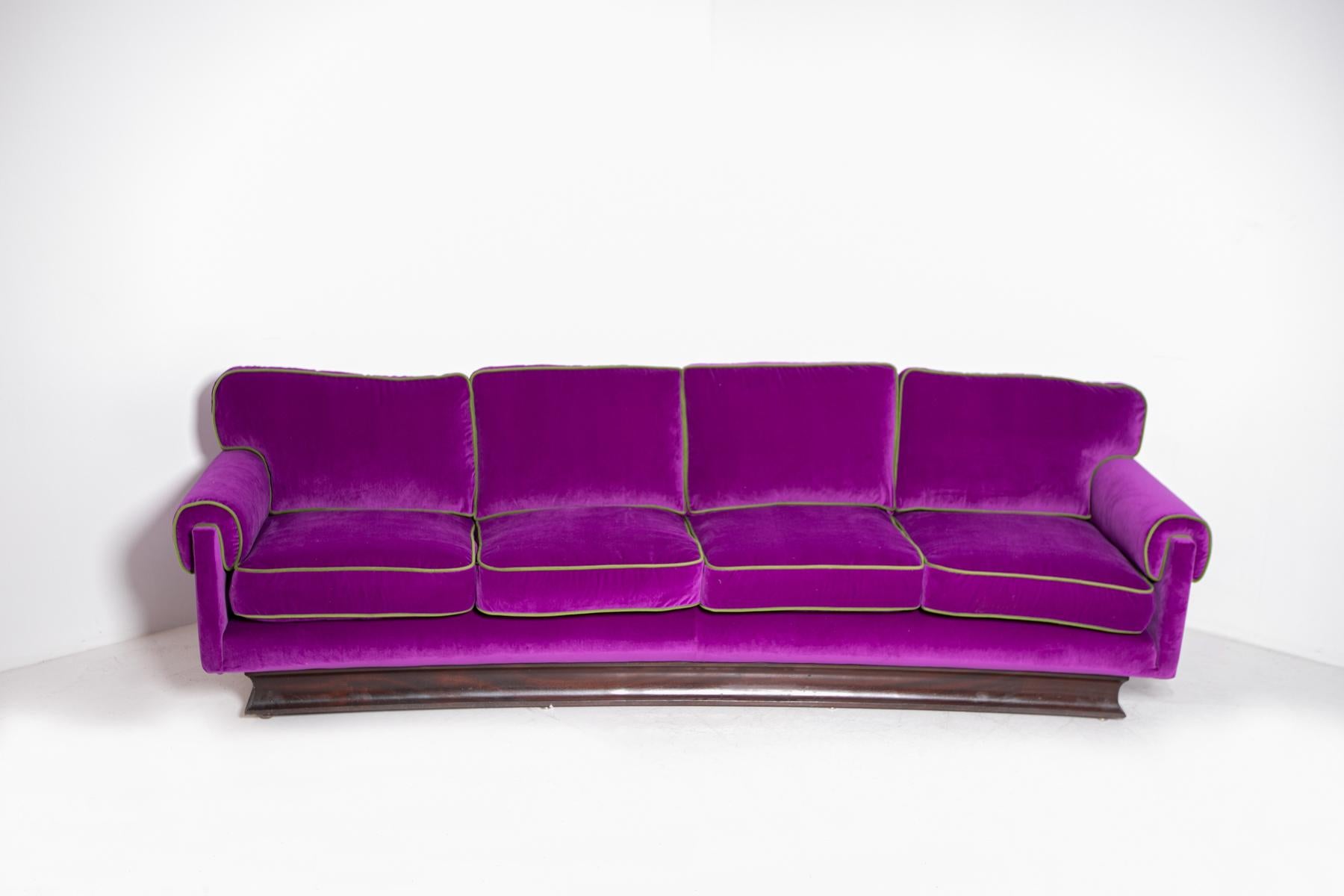 Fantastic and eccentric four seater sofa from the 1950s by Pierluigi Colli Model Claudia.
The sofa is a four seater and has been reupholstered in an elegant and sophisticated purple velvet. Note its edges covered in a bright green velvet