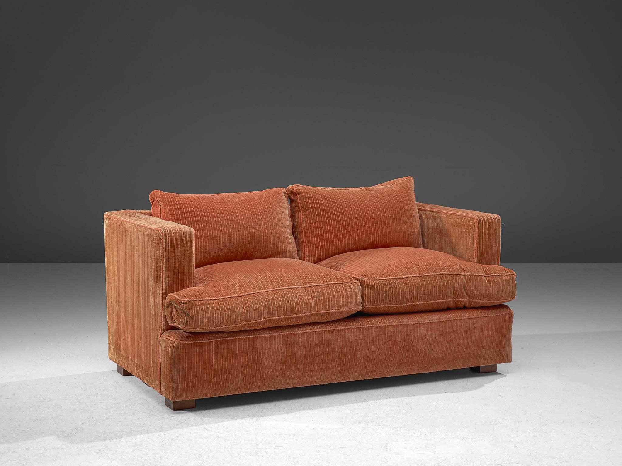 Sofa, corduroy velvet, wood, Italy, 1970s

This delicate sofa has a cozy and bulky appeal. An orange to peach velvet has been used to cover the seating. The textured surface of the fabric, consisting of vertical lines, adds a graphical touch to the