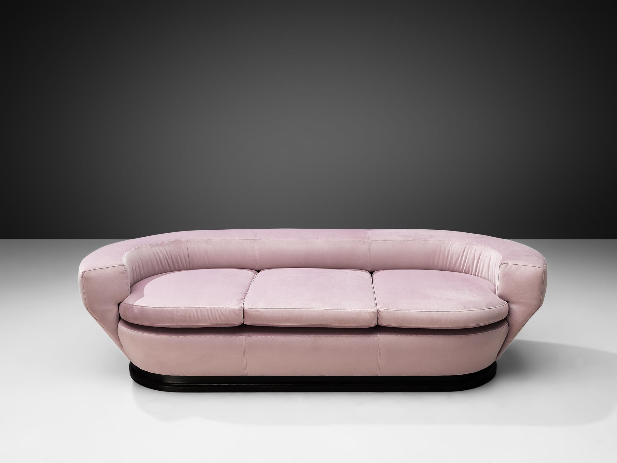Three-seat sofa, velour upholstery, darkened wood, Italy, 1960s.

This Italian sofa has three seats, an elegant tapered base and a low backrest. The backrest surrounds the seatings and merges seamlessly in to the armrests. The base rests on a