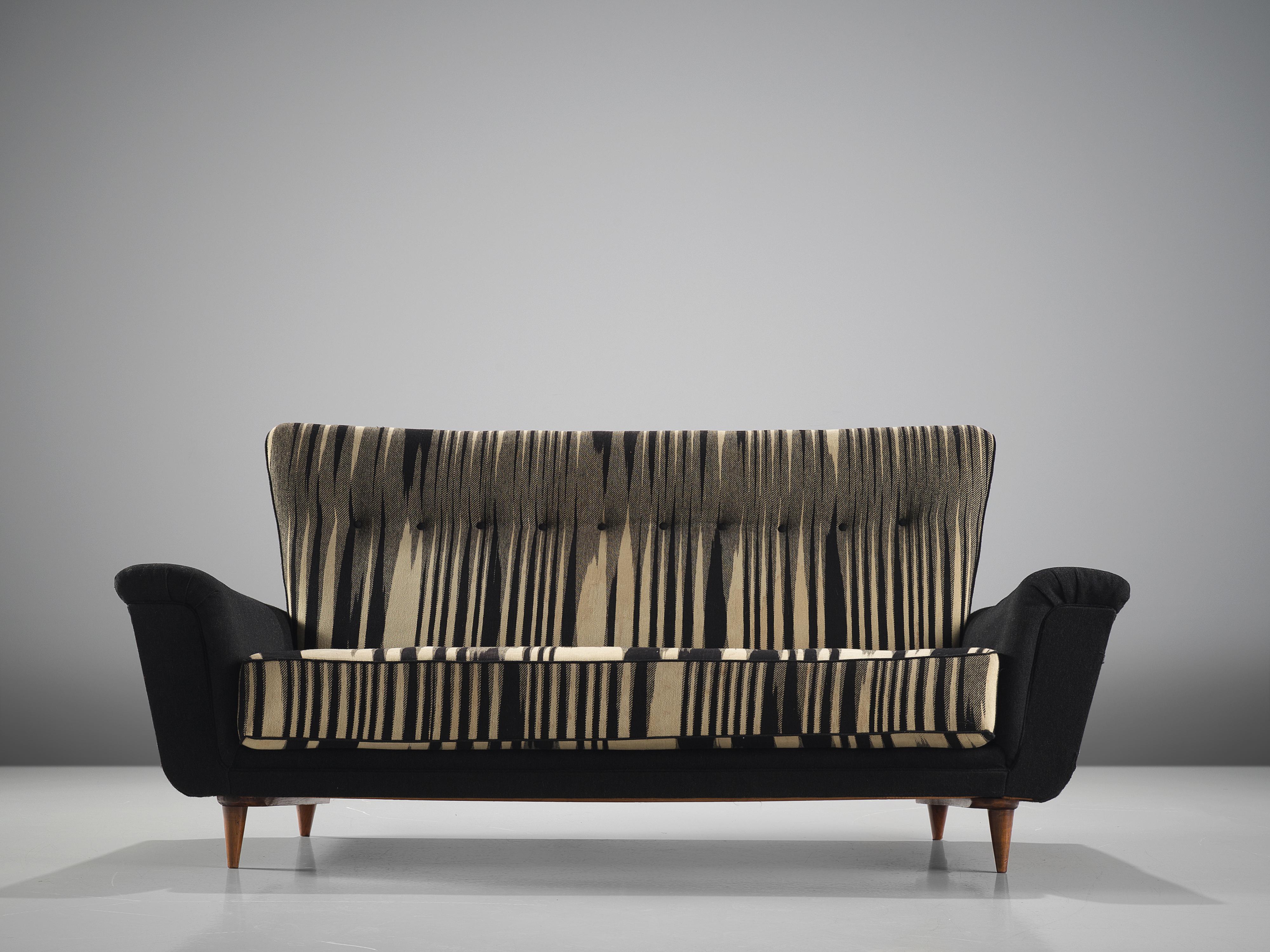 Theo Ruth for Artifort, sofa, in original black and white fabric, wood, The Netherlands, 1950s.

This sofa is an iconic example of an Artifort sofa designed by Theo Ruth in the 1950s. The sofa is on the one hand simplistic, with elegant, subtle